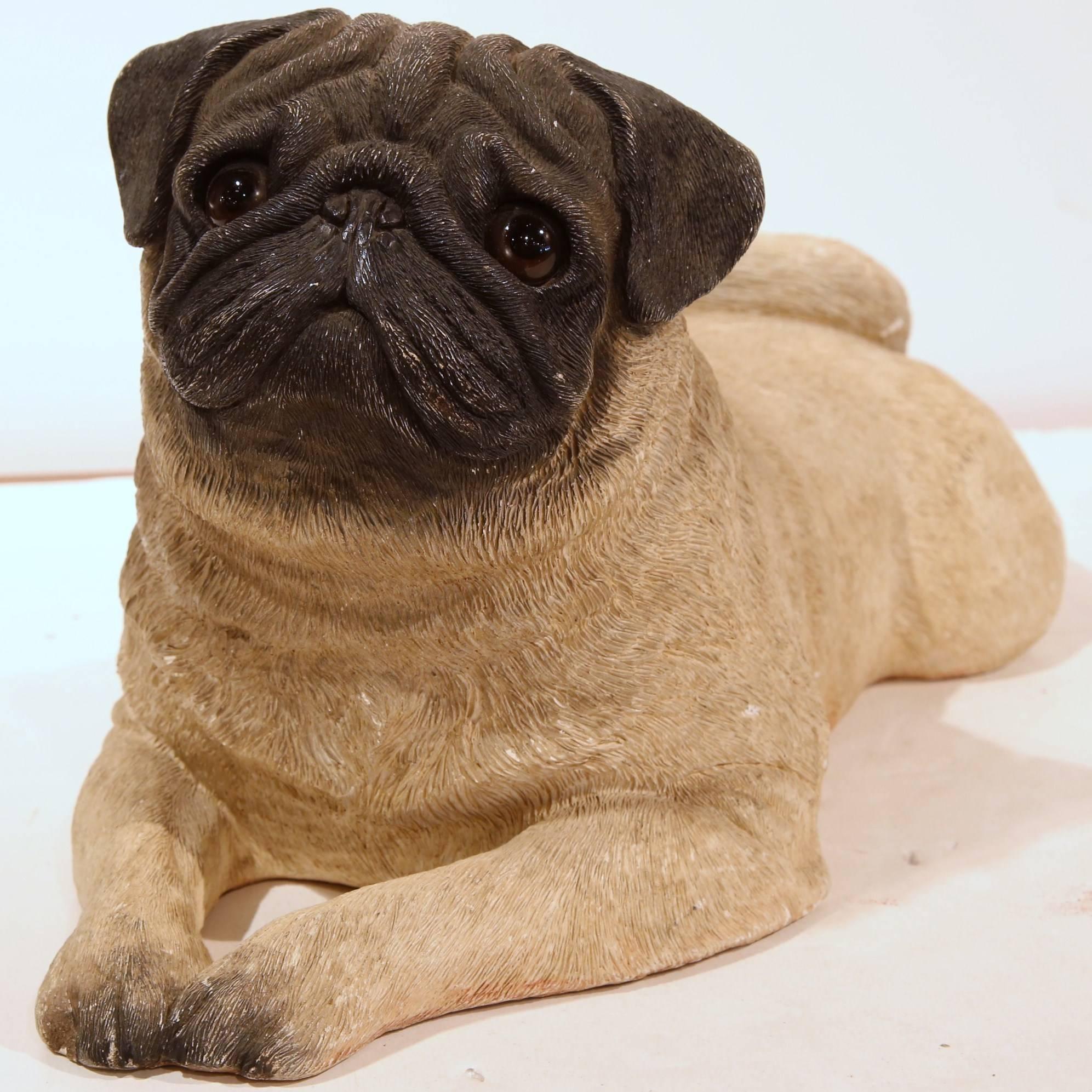 Dog lovers will appreciate this realistic vintage pug. Crafted in France, circa 1920, the antique dog sculpture features a resting puppy pug; the canine with wonderful facial expressions, has detailed features including on the neck and hair, and has