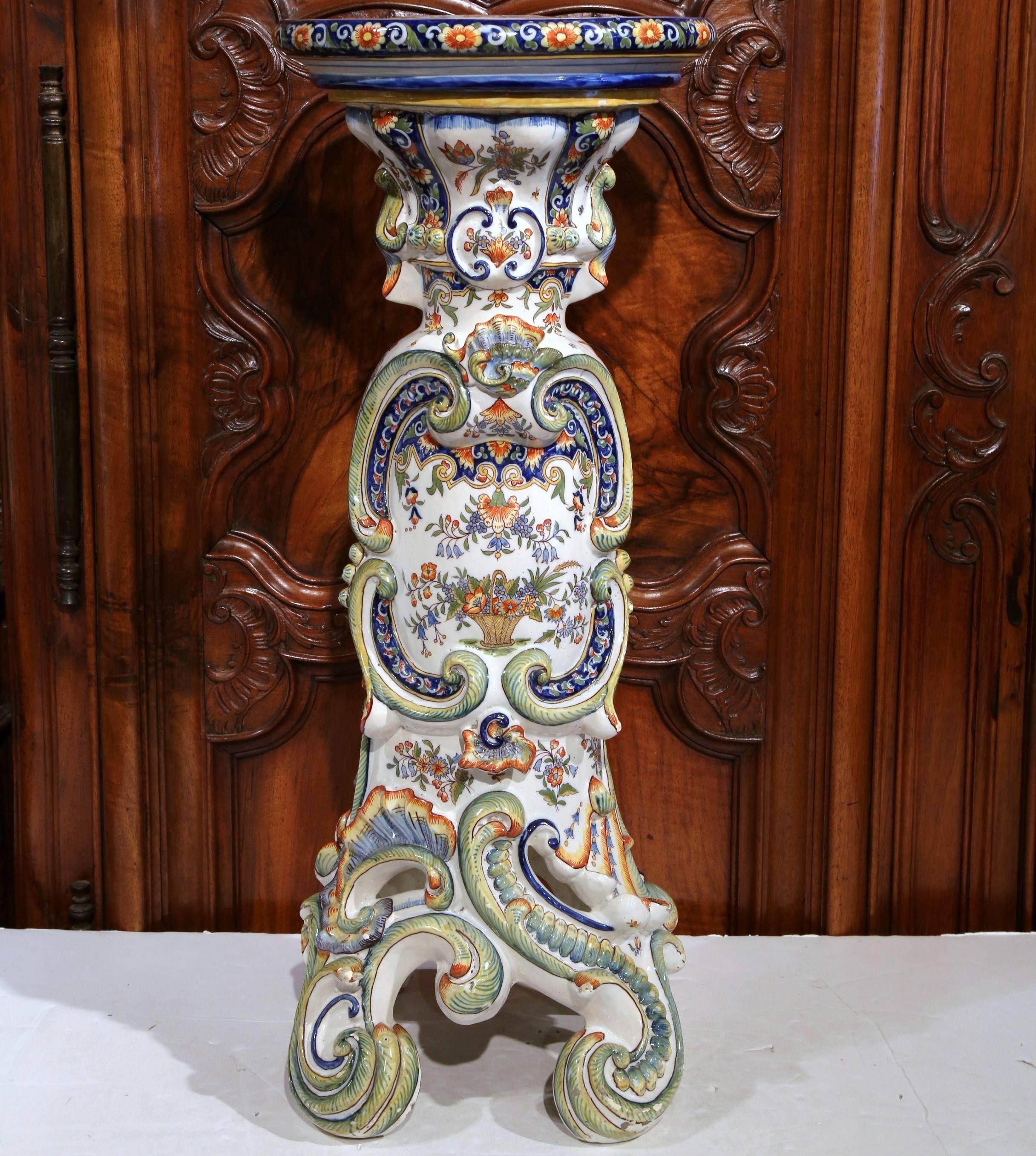 Bring practicality with this small colorful Majolica martini pedestal; crafted in Normandy, France, circa 1880, the elegant faience table sits on three scroll feet and features unique lines and carvings around the stem and neck under the round