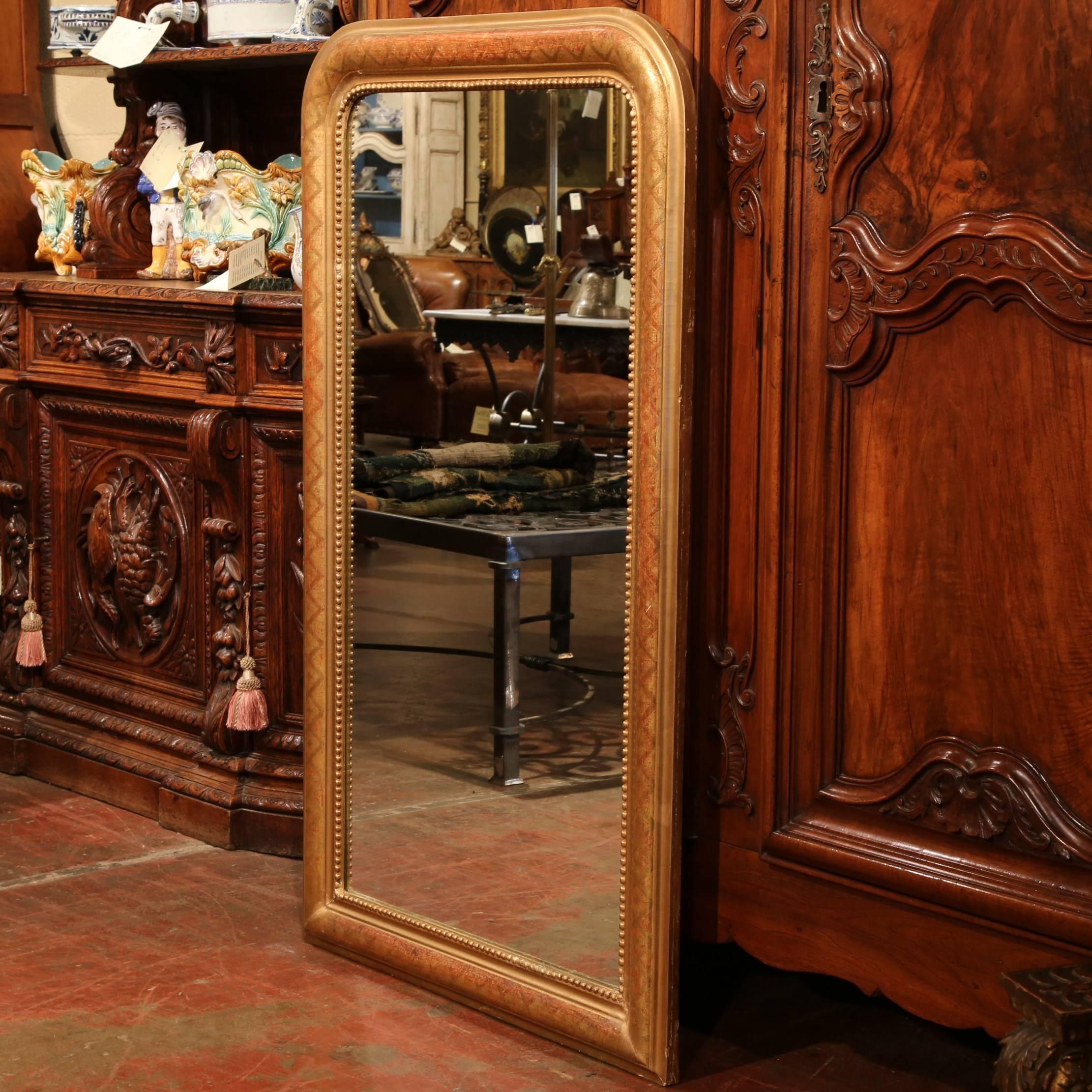 This elegant Louis Philippe wall mirror was carved in France, circa 1850. The frame has its original gilt finish with red showing thru, lattice design and beads around the frame. Excellent condition with rich finish, original back and mercury glass.