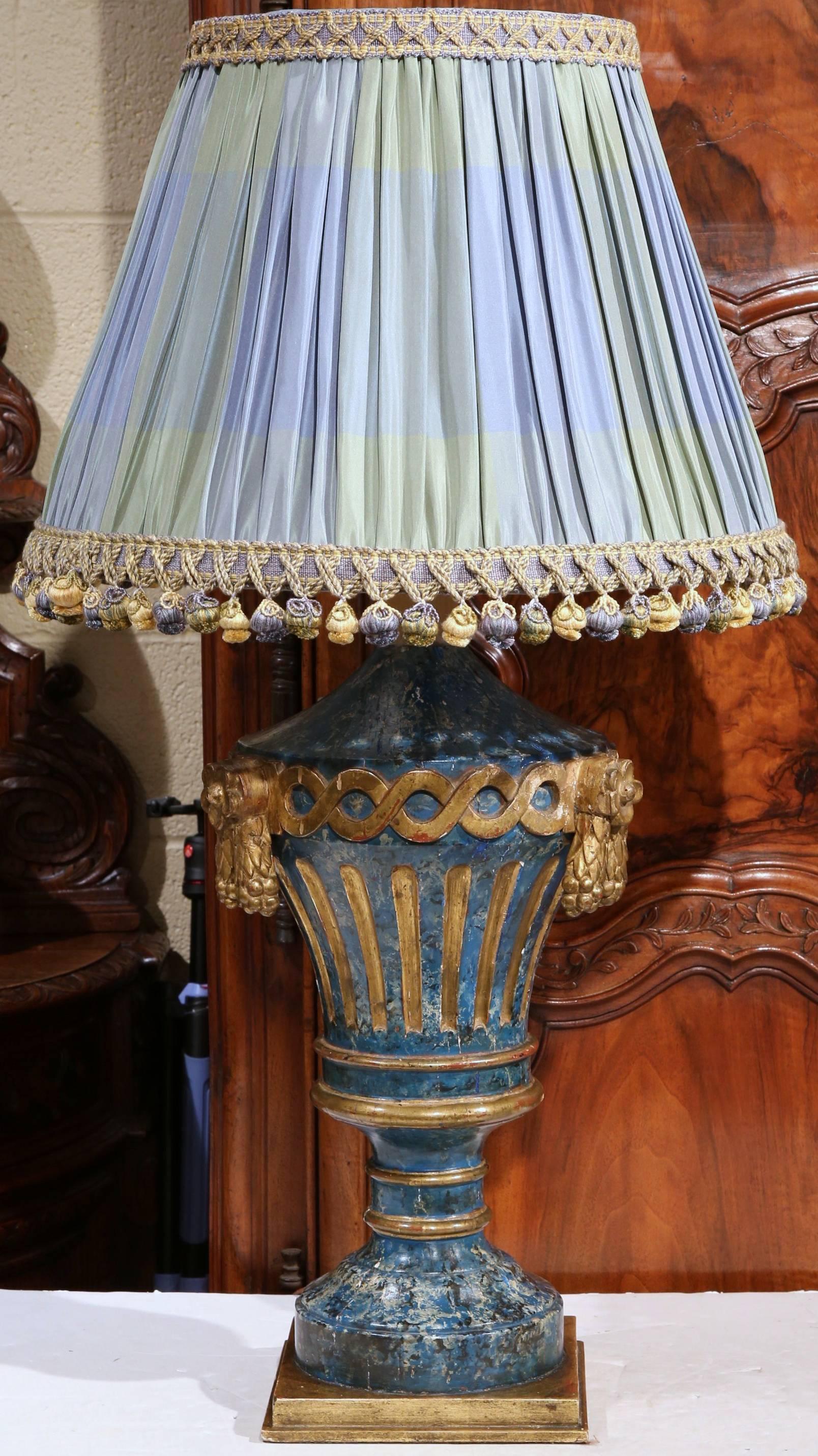 This elegant pair of lamps were crafted in Italy, circa 1870. The tall, carved vases are in the form of Medici vases and are decorated with a painted marbleized texture with gilt accents. The large vases with carved wooden tassels and ropes on both