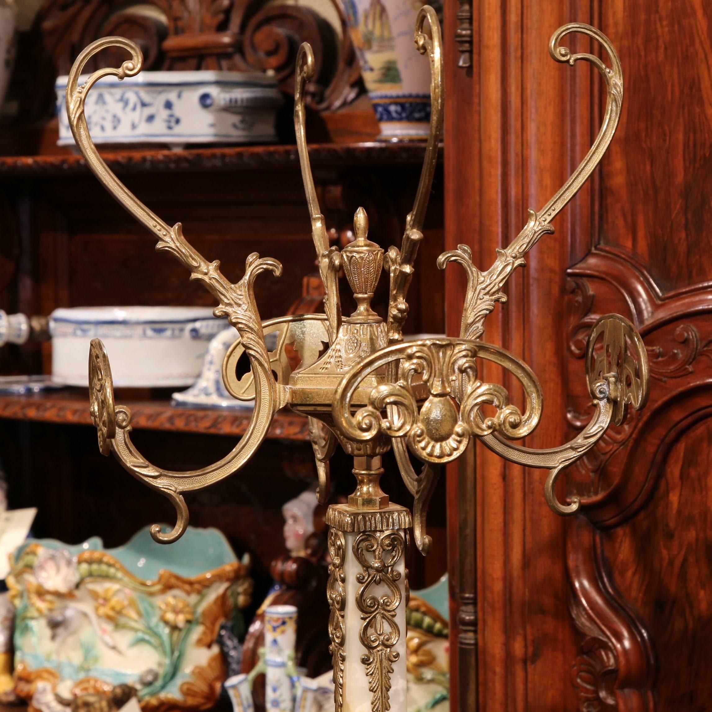 An old world addition to any home, this tall vintage hat rack is perfect to hold your clothing and adorn your entryway, master bathroom or closet. The 1960s piece is crafted from onyx and brass and has numerous details including women's faces and