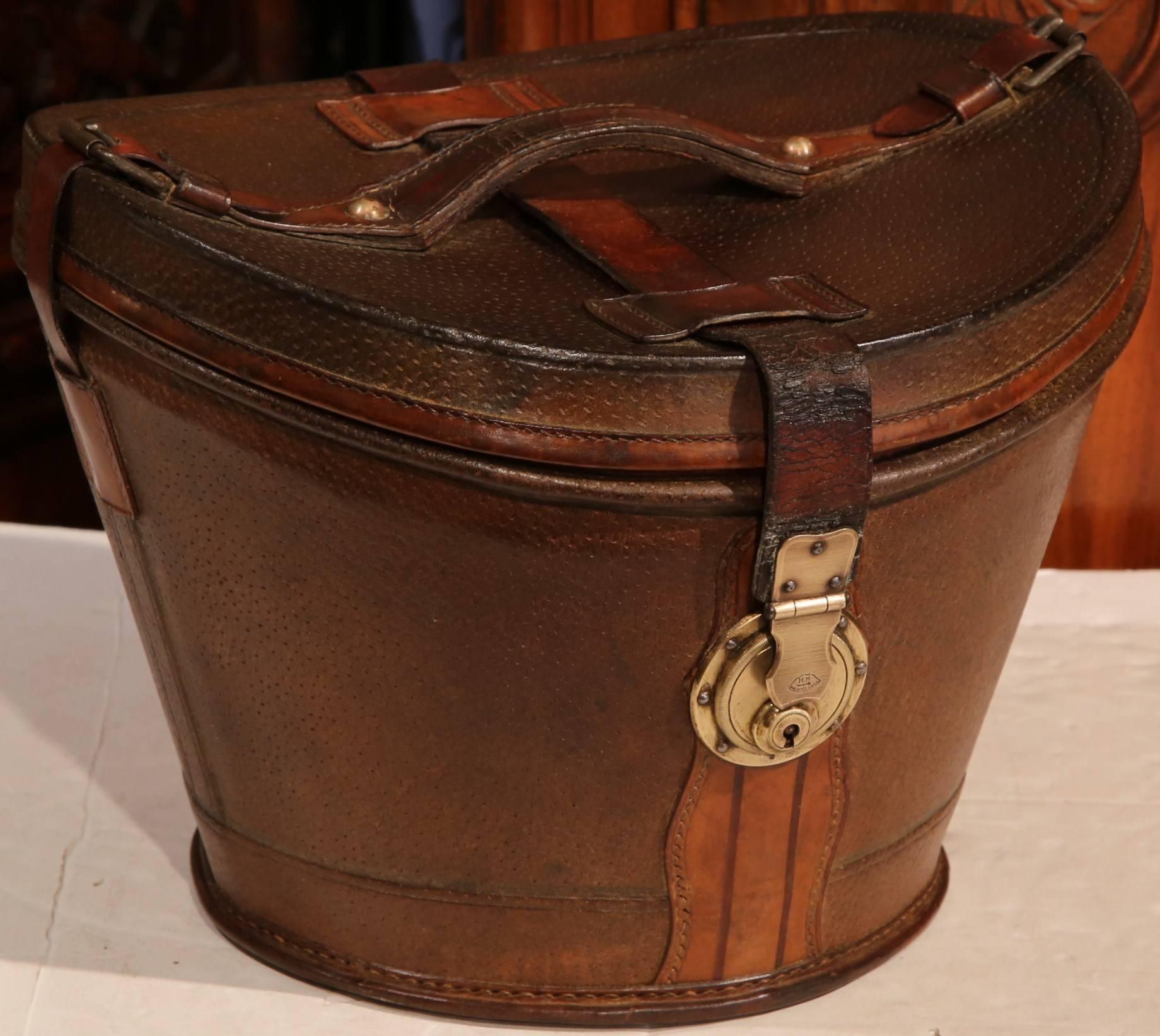 This exquisite, antique pigskin hat box was crafted in France, circa 1790. This locked leather box is in wonderful condition and is outfitted with a brass lock, leather straps and handle, and also has its original interior fabric. The piece is in
