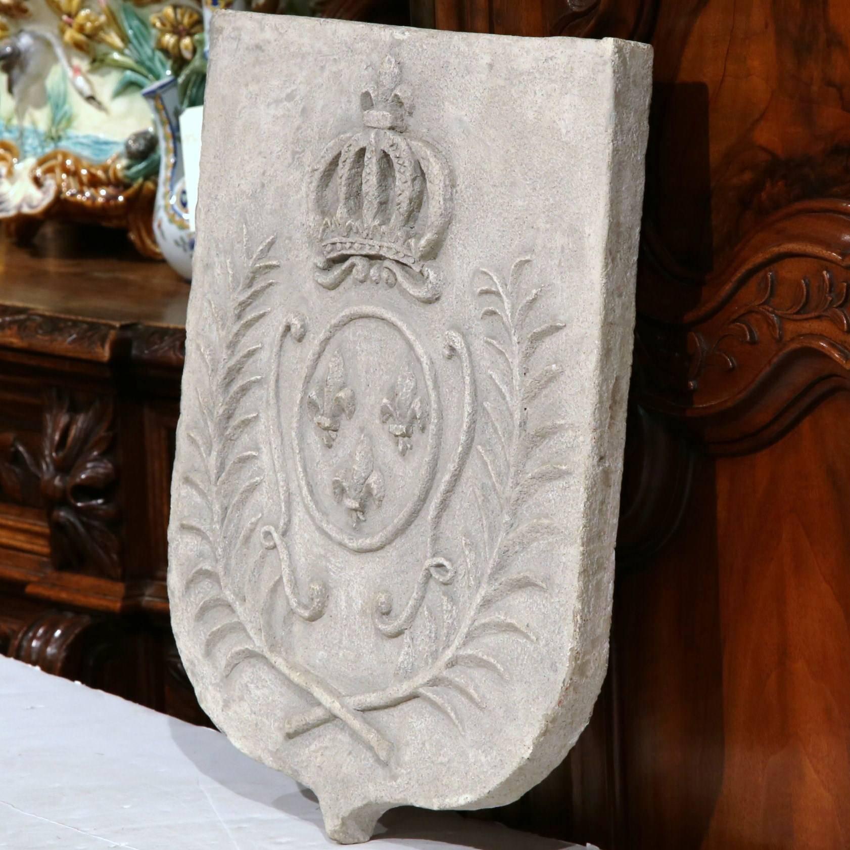 This elegant, antique cast stone crest represents the grand royal coat of arms of the kingdom of France. The traditional crest was made circa 1890 and has three fleurs-de-lys and the king's crown. The stone piece is in excellent condition and has a