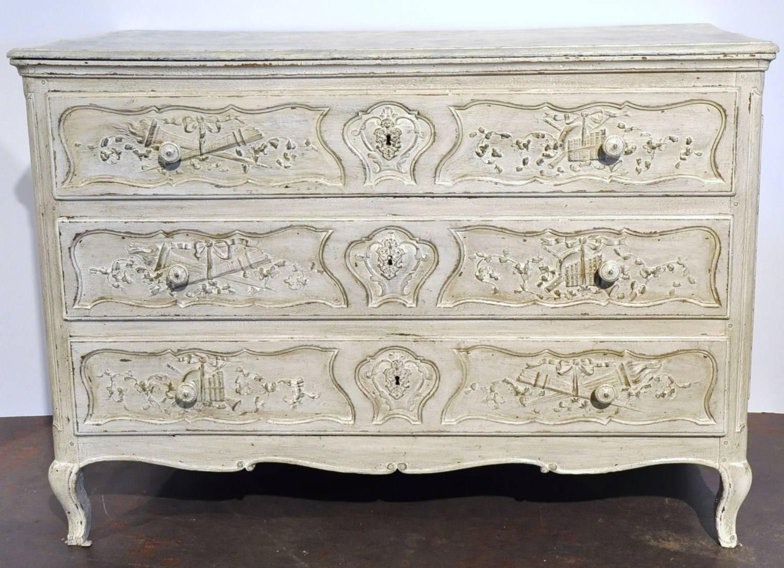 Decorate an entry or a bedroom with this elegant antique chest of drawers. Crafted in northern France, circa 1780, the commode features three carved drawers across the front embellished with iron pulls, a scalloped apron over the scroll feet and