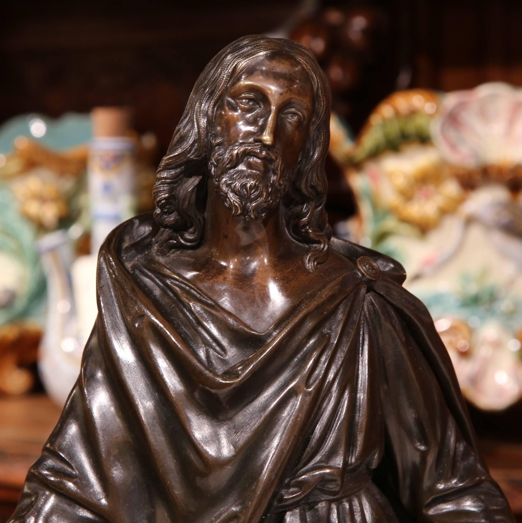 This large, antique bronze religious sculpture was crafted in France, circa 1870. The composition depicts our Lord Jesus Christ with open arms and praying; He is flanked by two knelling women in adoration at his feet. The traditional Christian