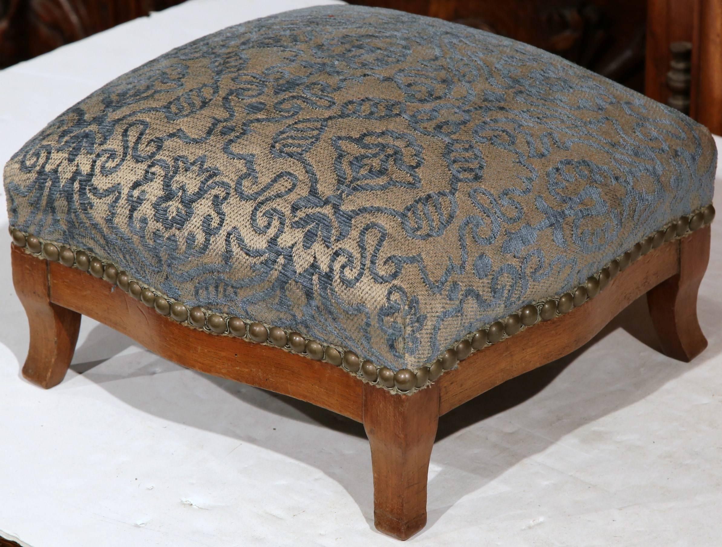 Fine antique foot stool from France, circa 1870, with scrolled feet and shaped apron, this stool has been redone with fine blue and grey cut velvet and antiqued nailheads. Excellent condition.