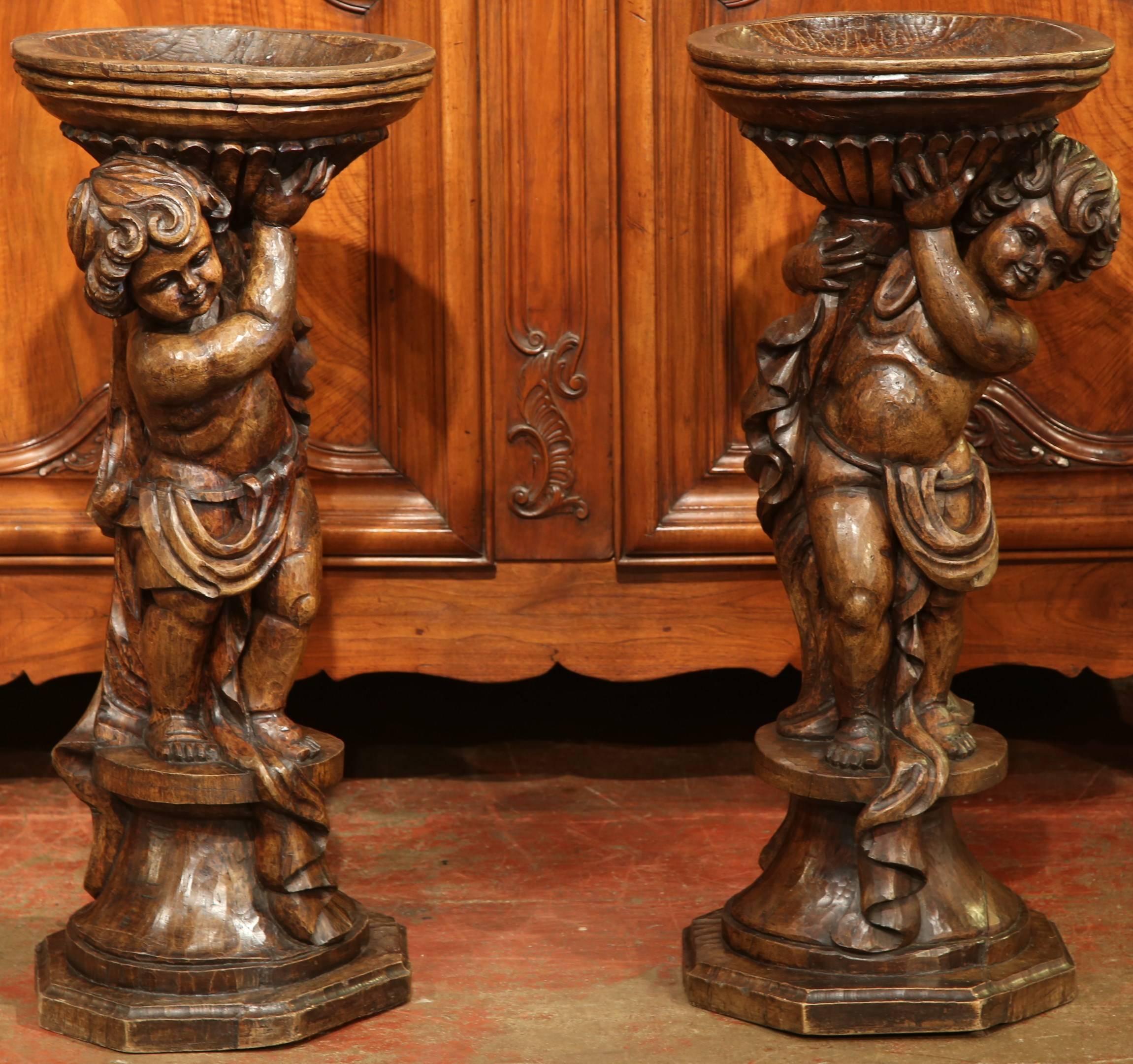 Patinated Tall Pair of 18th Century French Hand-Carved Walnut Plant Stands with Cherubs