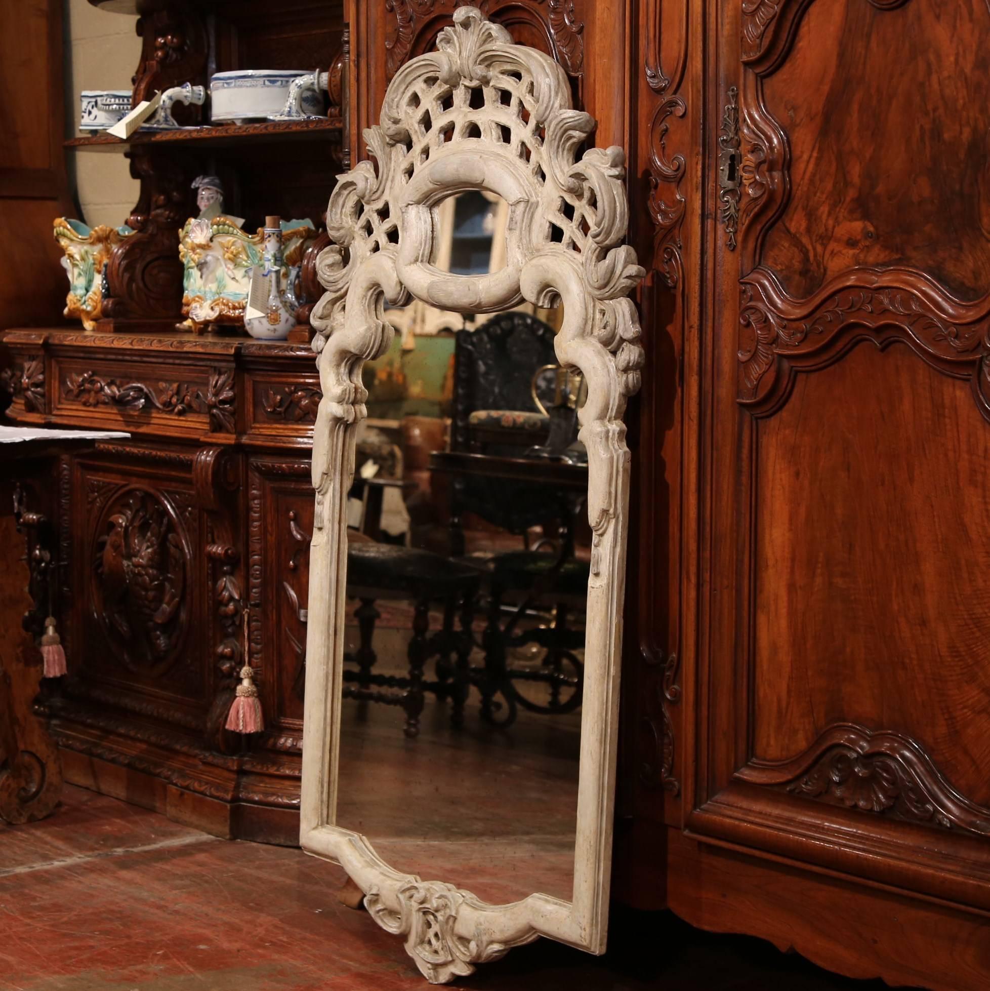 Make a style statement in your living room, bathroom or bedroom with this hand carved, painted mirror; crafted in Italy circa 1920, the rectangular mirror has a unique, heavily carved frame with shell at the pediment, and is hand painted in a grey