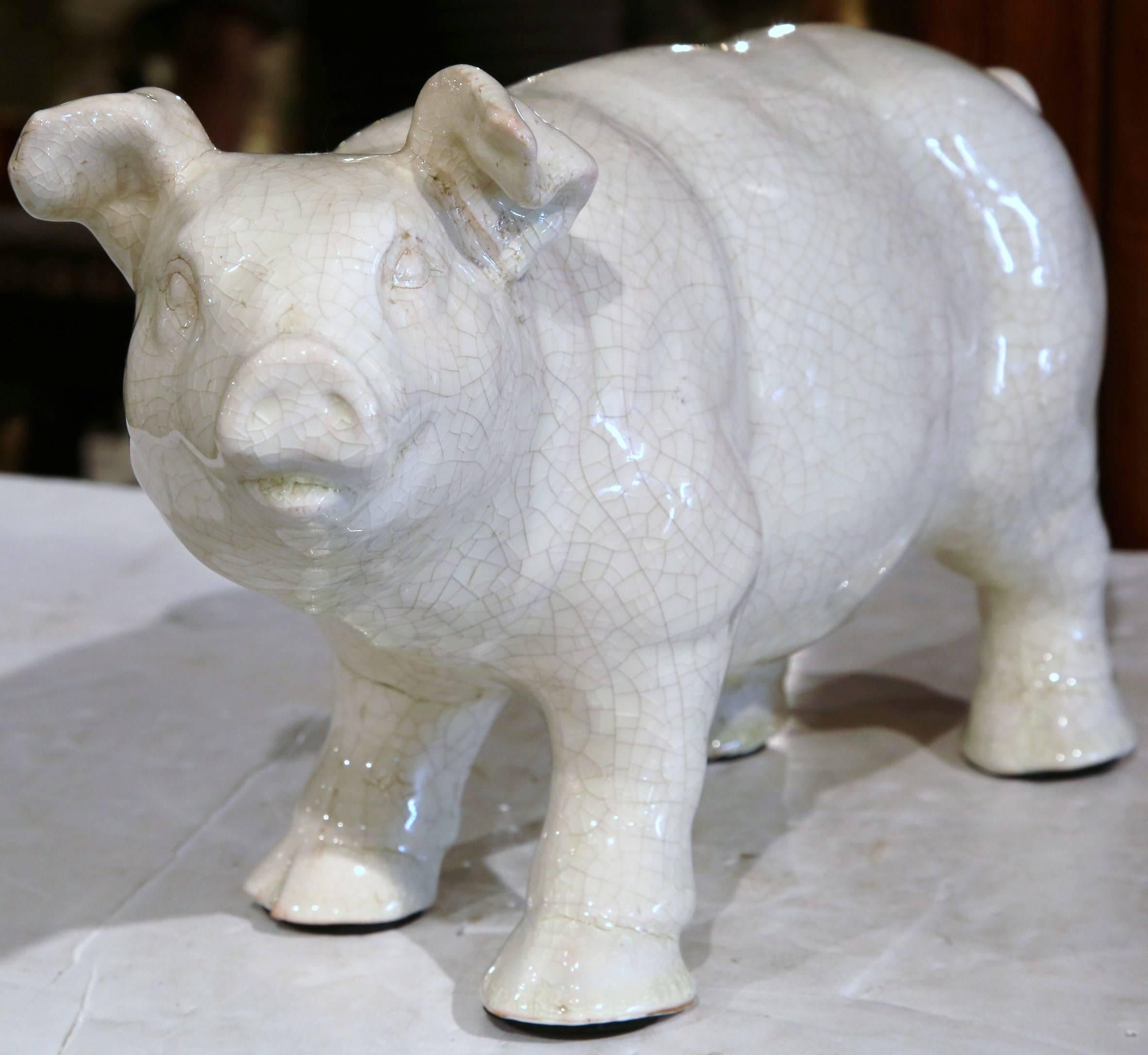 Decorate a kitchen island with this Classic, standing, ceramic pig sculpture. Crafted in northern France, circa 1960, the vintage faience farm animal figure has a charming expression, a sweet face, and a crackled, rustic finish. This piece is a