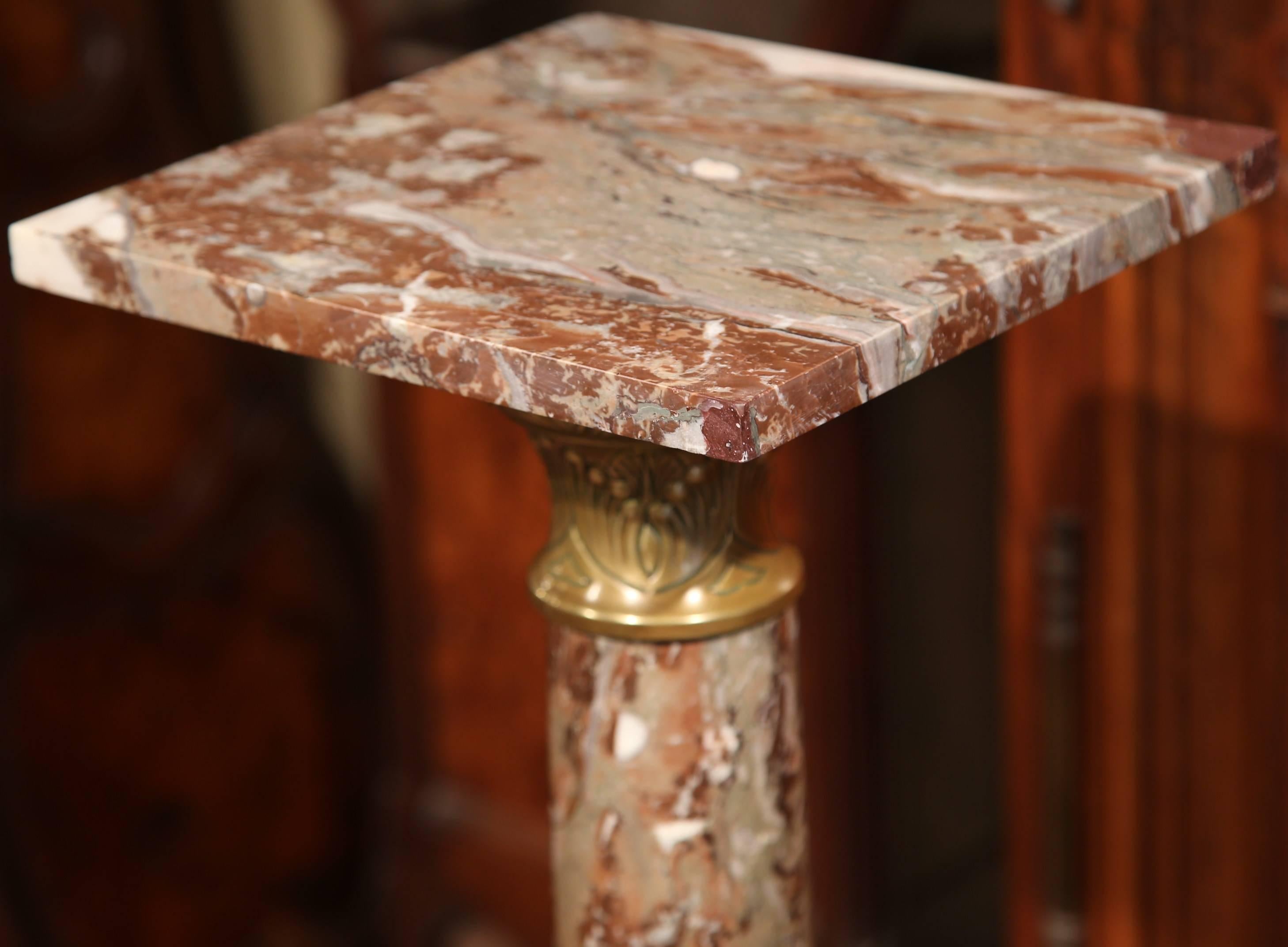 This elegant, antique pedestal was carved in France, circa 1860. The pedestal is made from a white veined, red marble and features brass repousse accents at the base and under the removable top. This piece is the perfect size to hold a bronze or