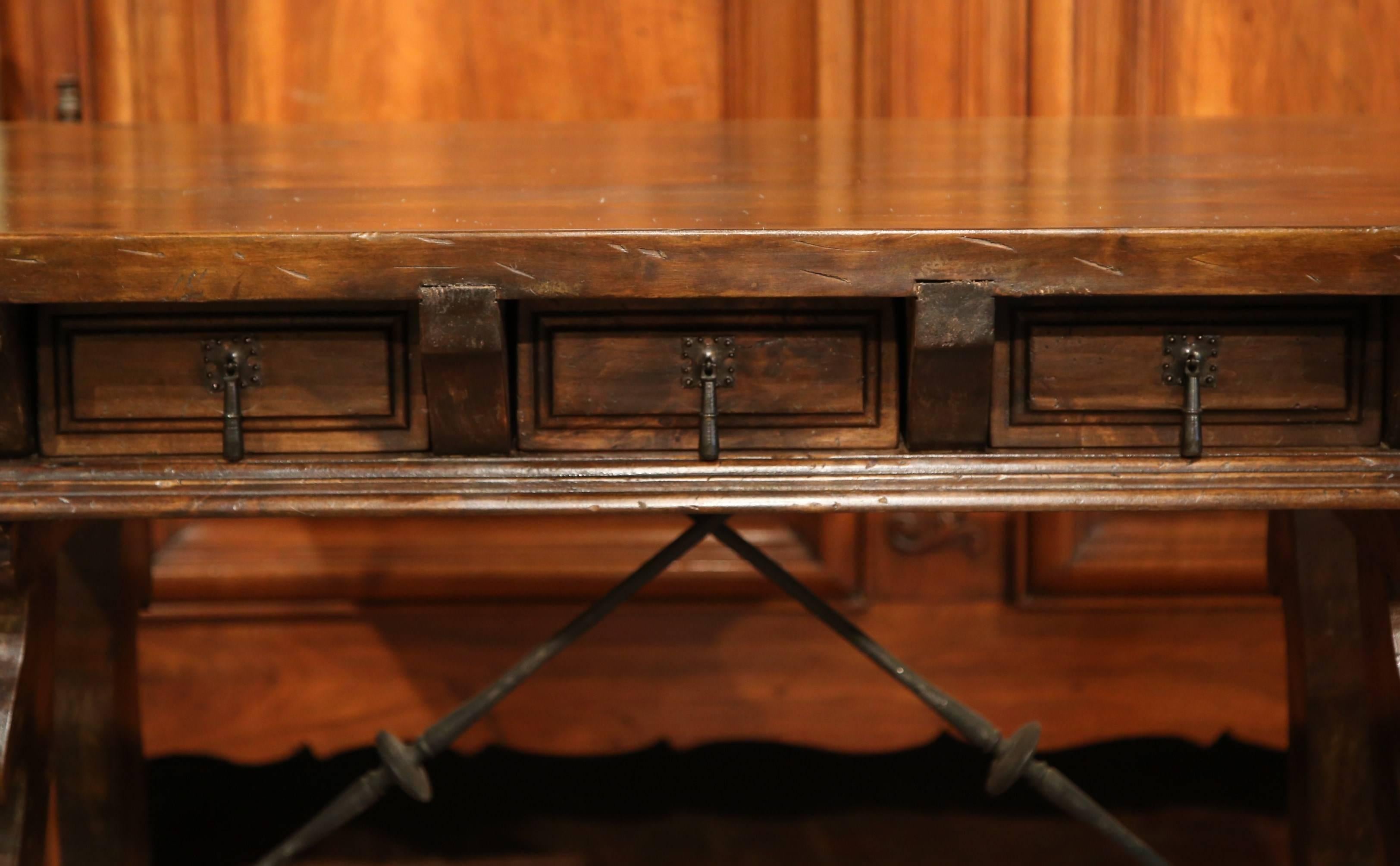 Hand-Carved Early 20th Century Spanish Walnut Desk with Iron Stretcher and Two Drawers