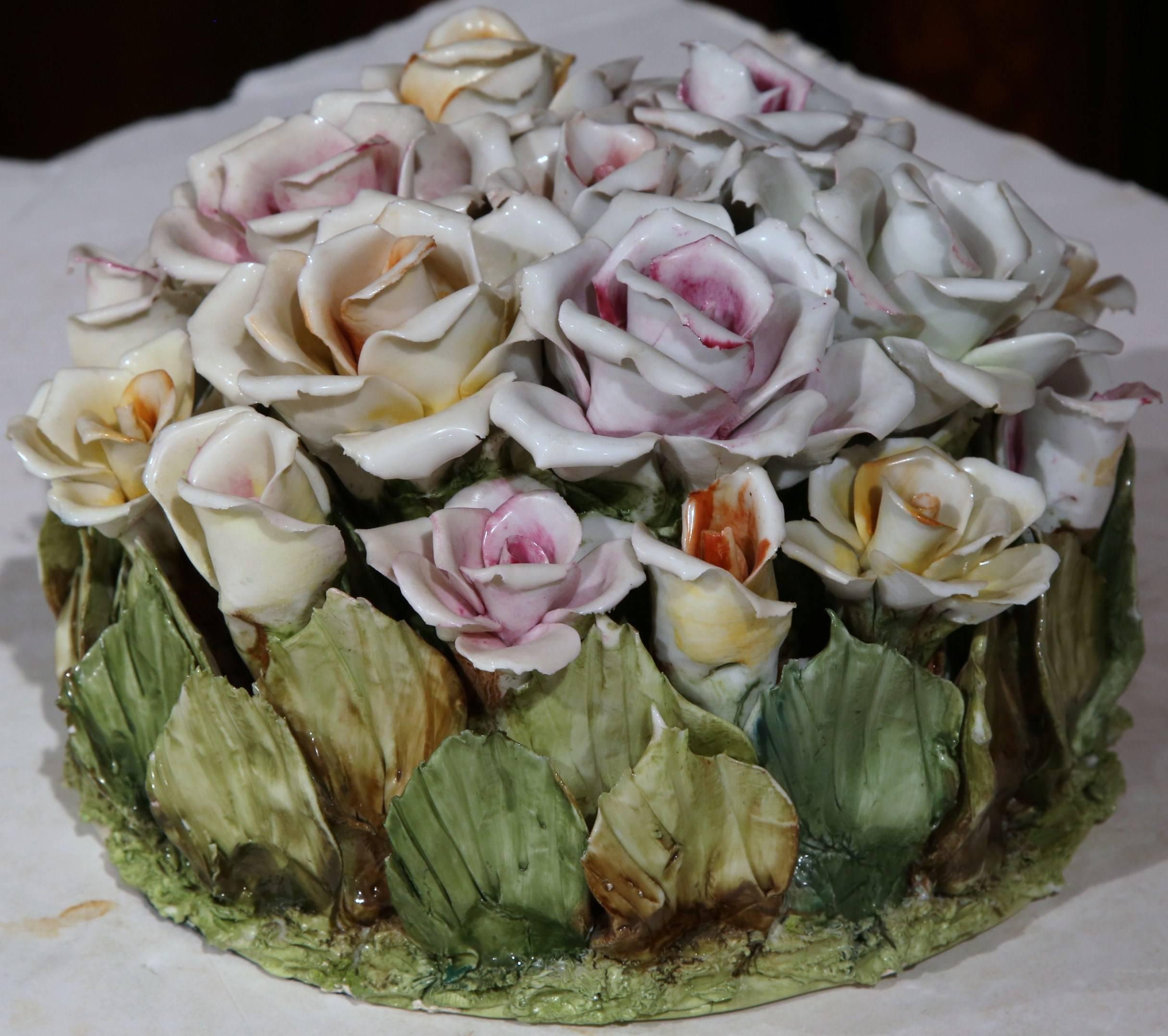 Decorate a tabletop with this circular, Majolica roses basket from France, circa 1920. The colorful piece has a palette of green, yellow, pink and white and has intricate carvings from every angle. This delicate, beautiful piece is in excellent