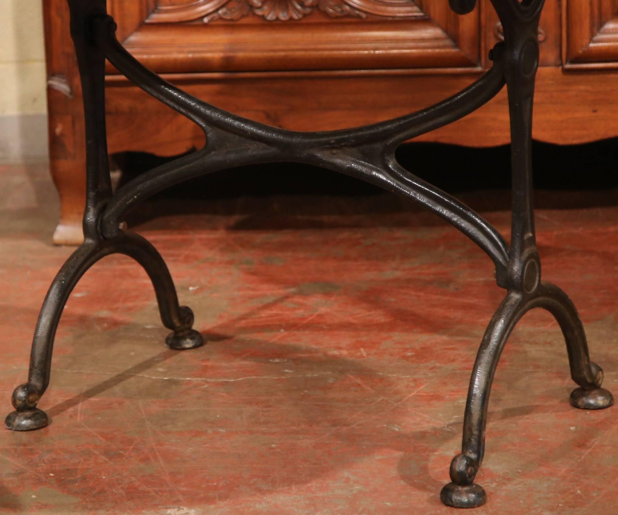 Bring the beauty of Paris, France into your home with this sophisticated black iron and white marble antique oval bistrot table. Crafted in 1920, this table is a great size for a small breakfast room, or a work table to Craft pastries. The table is