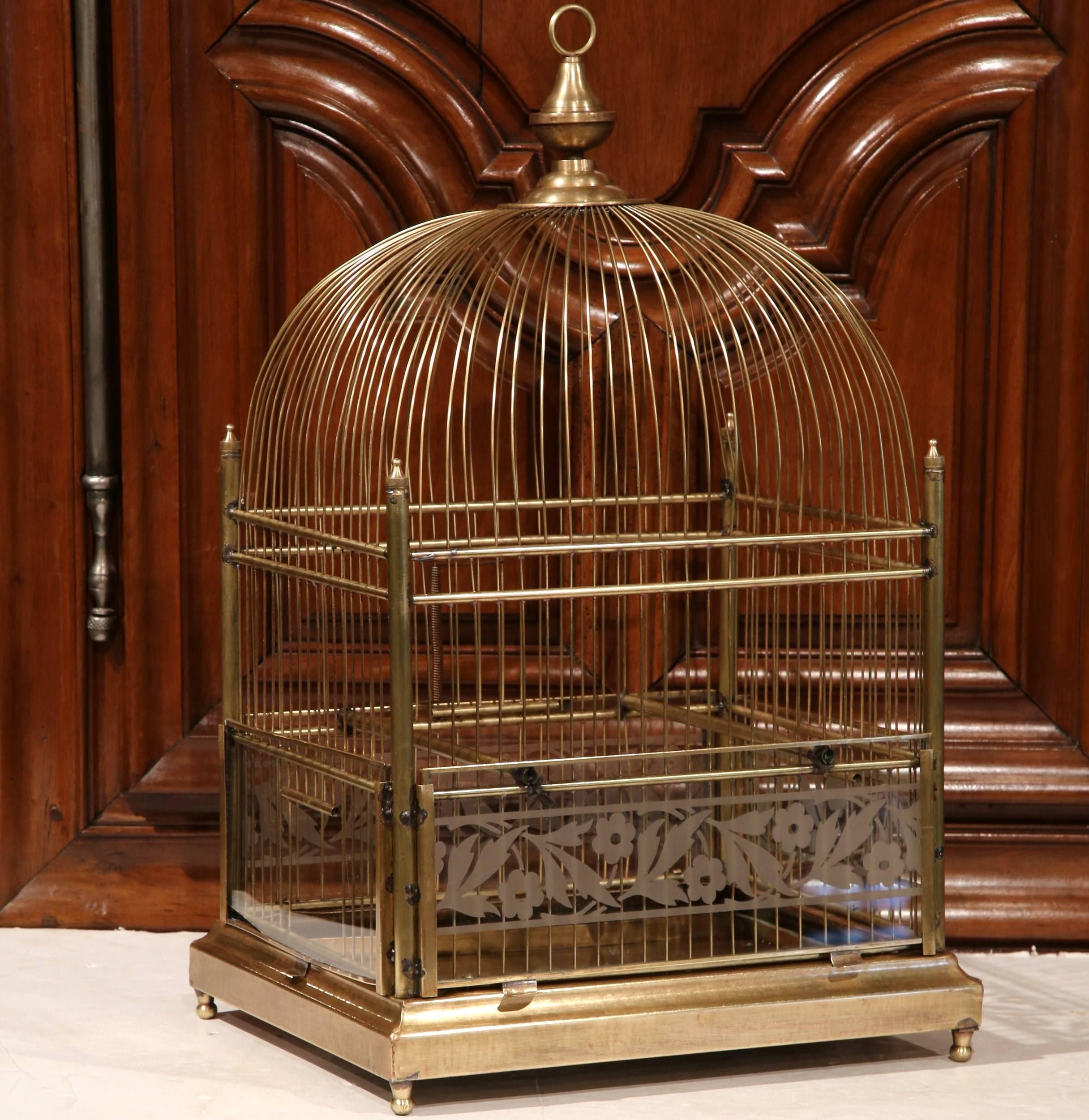 Add dimension to your home with this antique bird cage from France, circa 1870. Made of brass, this Napoleon III period cage is in wonderful working condition. The cage has four original glass panels with painted flowers and leaves on the back side.