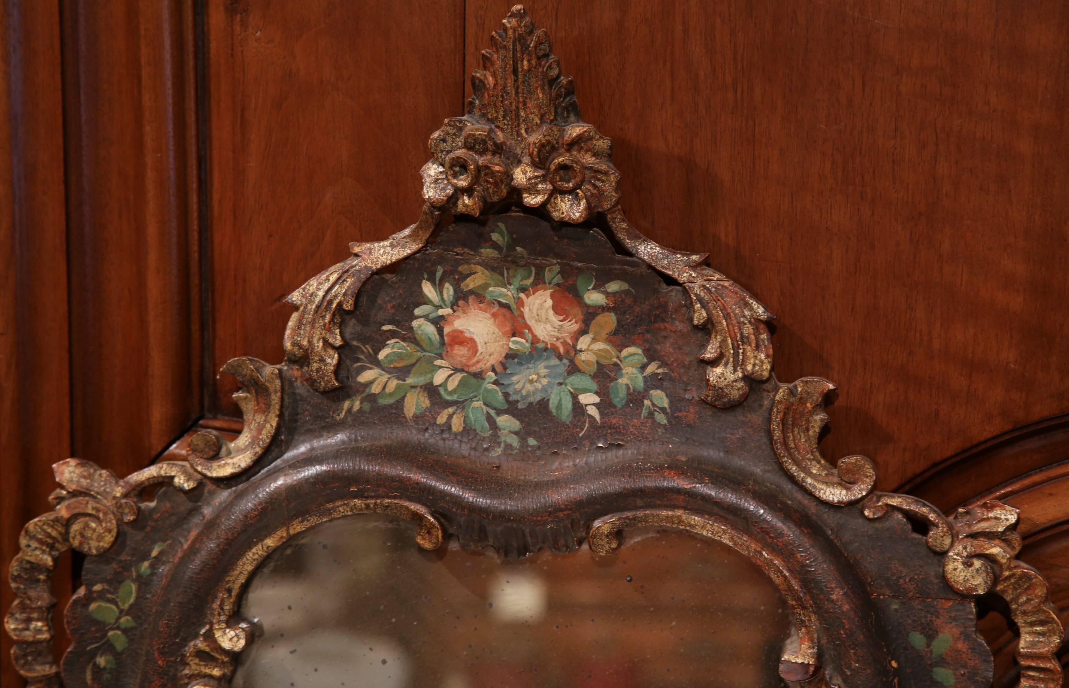 Decorate a dressing room or powder bathroom with this elegant, feminine hand-painted mirror from Italy, circa 1870. This small, colorful, nicely carved mirror features hand-painted flowers and leaves with gold leaf accent around the edges. The