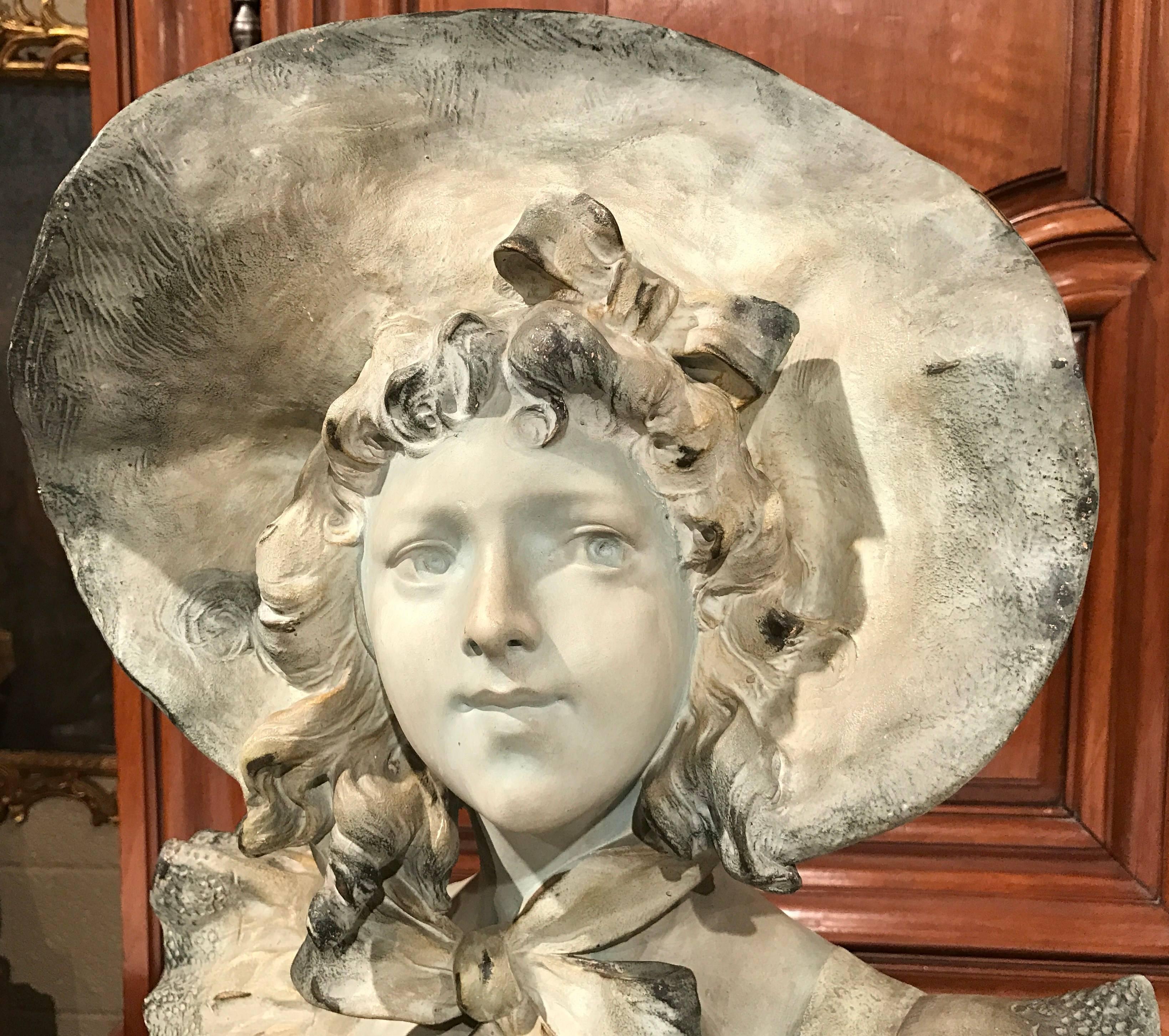 This tall, antique terracotta bust is the perfect addition to any elegant room. Sculpted in Italy, circa 1870, the earthenware bust has a highly detailed face of a young woman, with beautifully sculptured features and hair. The bust is signed on the