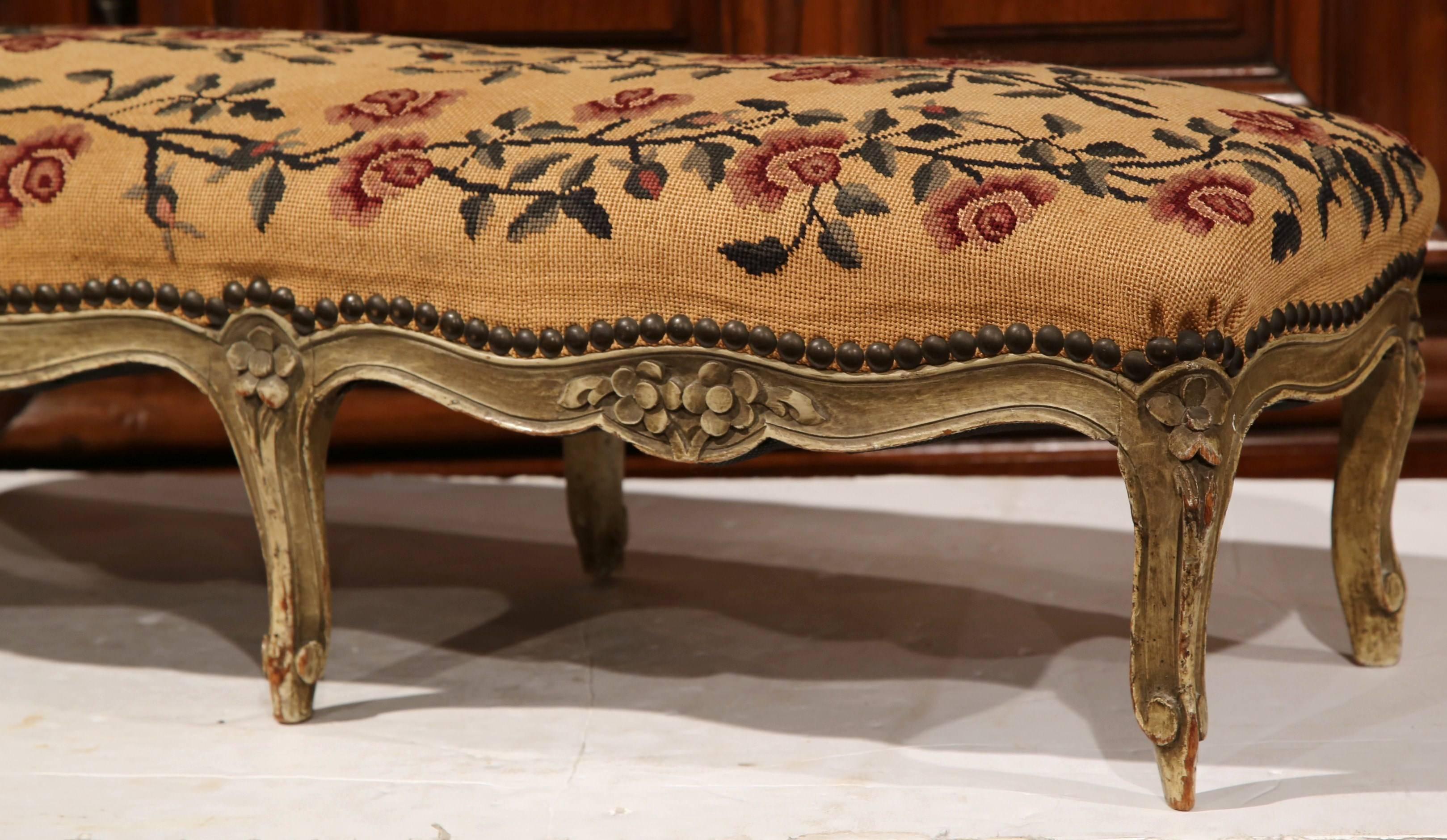 Beautify an entryway, hallway or formal living room with this elegant six-leg foot stool. Crafted in France, circa 1870, the stool features handwoven floral needlepoint, a hand-carved apron and cabriole legs. The tapestry on the seat is a soft