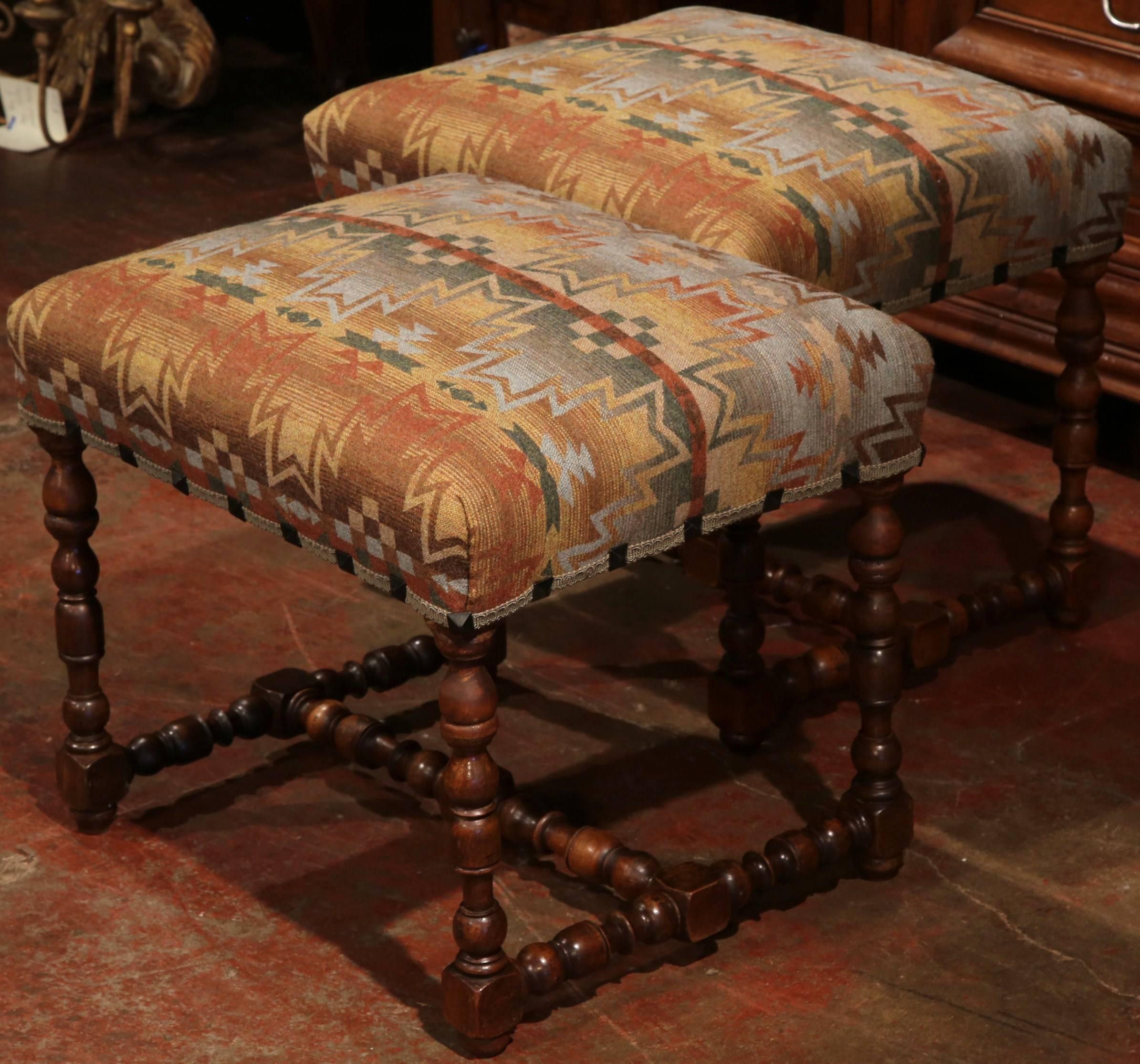 Nice pair of antique stools in fruit wood from southern France, circa 1880; reupholstered with a Ralph Lauren fabric in beige and brown palette, new trim and nailheads, turned legs and stretcher, these stools are in excellent condition with a rich