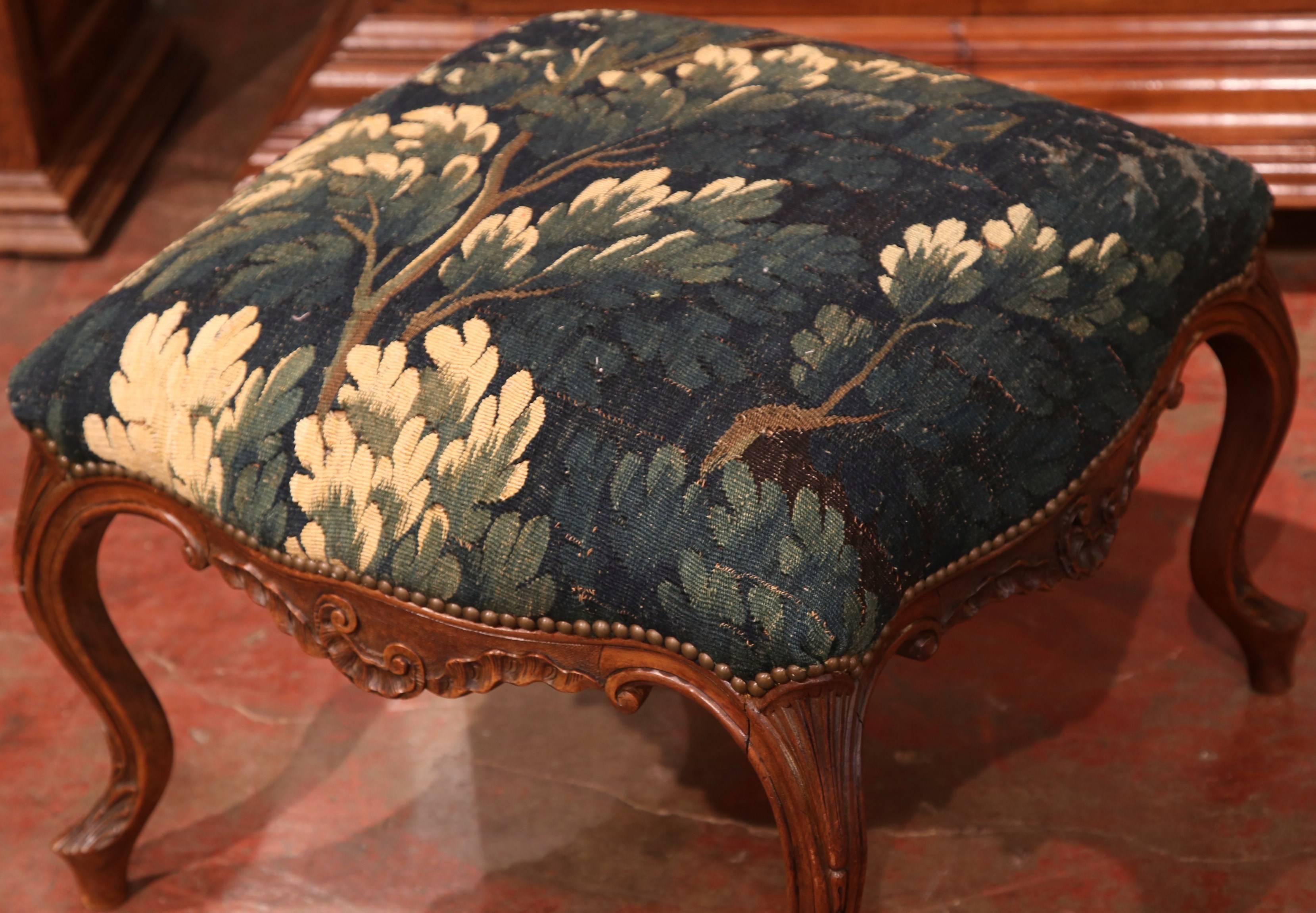 Add beautiful color to your living spaces with this elegant, antique Louis XV. Carved in Lyon, France, circa 1760, the stool stands on four cabriole legs and acanthus leaf decor on the shoulders, with shell motif on the scalloped apron. The seat has