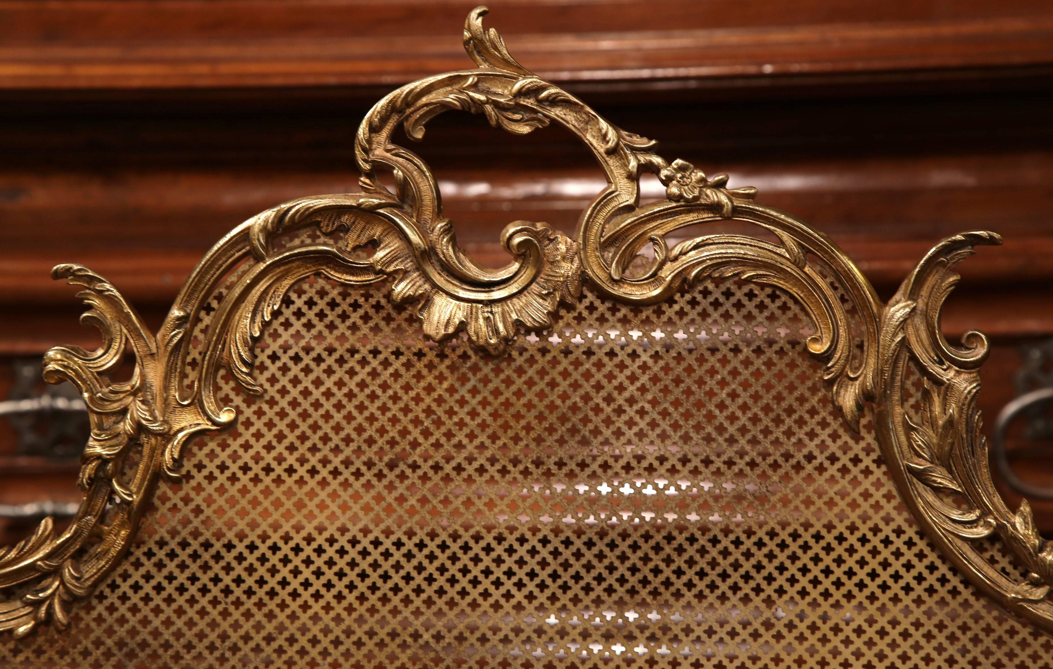Decorate your fireplace with this antique bronze screen, crafted in France, circa 1840. The cartouche shaped screen has Rococo style motifs like asymmetrical foliage swaths and mythological putti on either side. Mesh wire on the front. Excellent