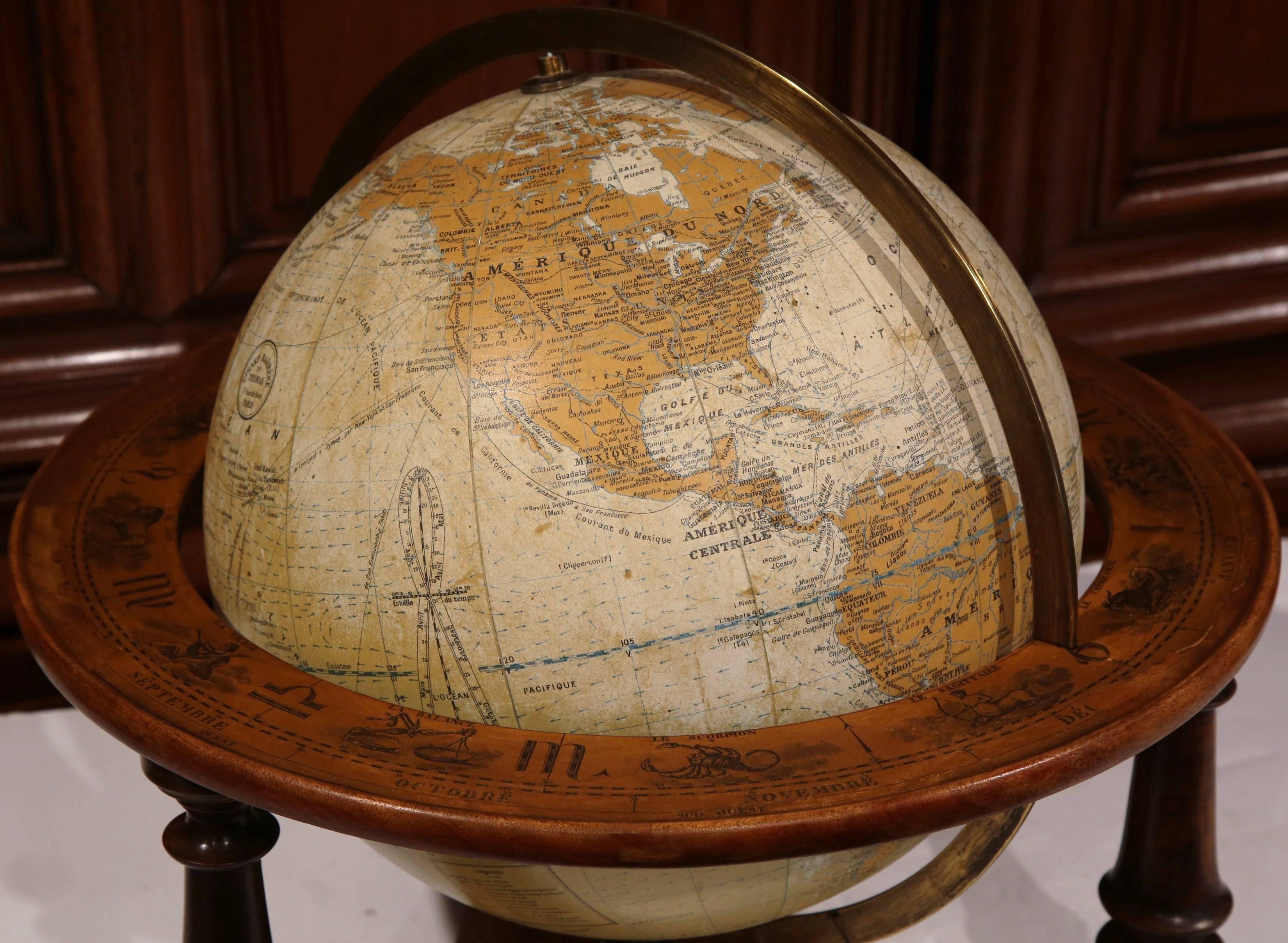 Complete your study or home office with this fine, antique terrestrial globe. Crafted in France, circa 1930, the globe sits on a sturdy walnut base with turned legs. The globe has a very detailed map in a muted, neutral palette of white and yellow.