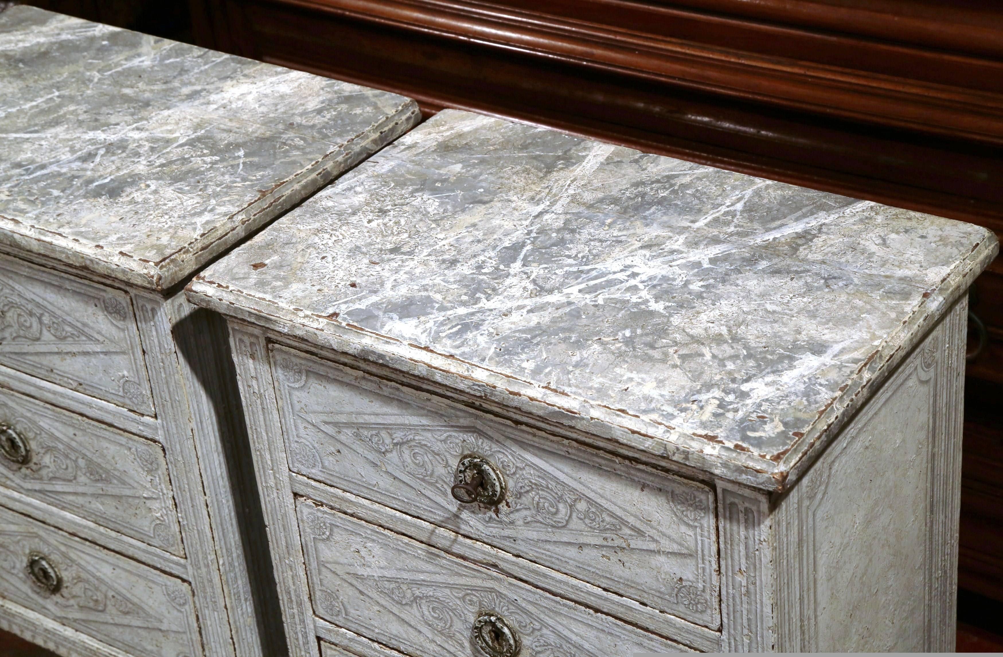 Complete your bedroom with this elegant pair of antique bedside tables from France, circa 1880. Painted in a beautiful gray and white palette, the side tables have three drawers across the front that are decorated with a geometric diamonds motif.