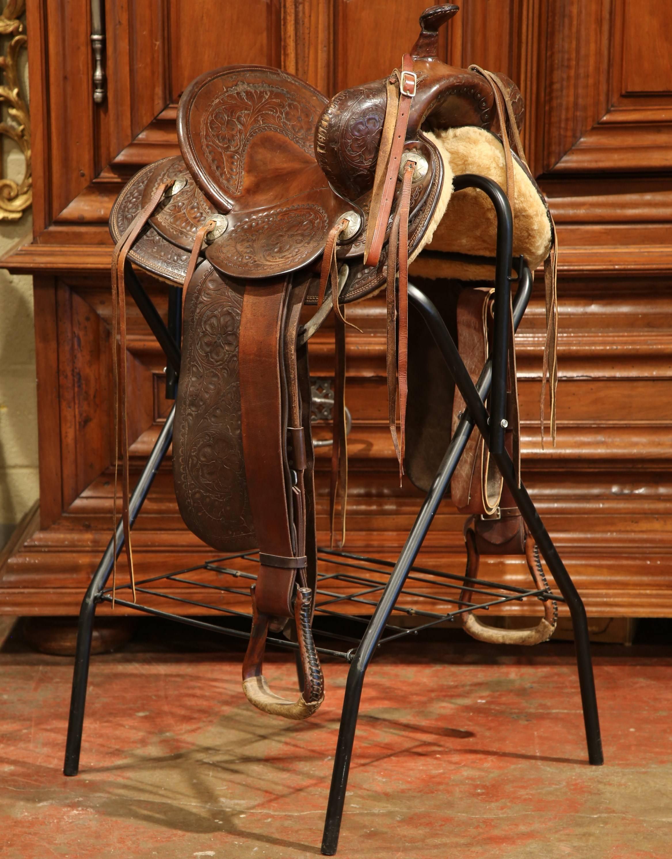 Decorate a ranch style home with this beautifully kept antique brown leather saddle from the early 20th century. The saddle, stamped on the front "Hamley and Co Makers Pendleton, ORE" and has initials JEJ on the back, sits on custom black