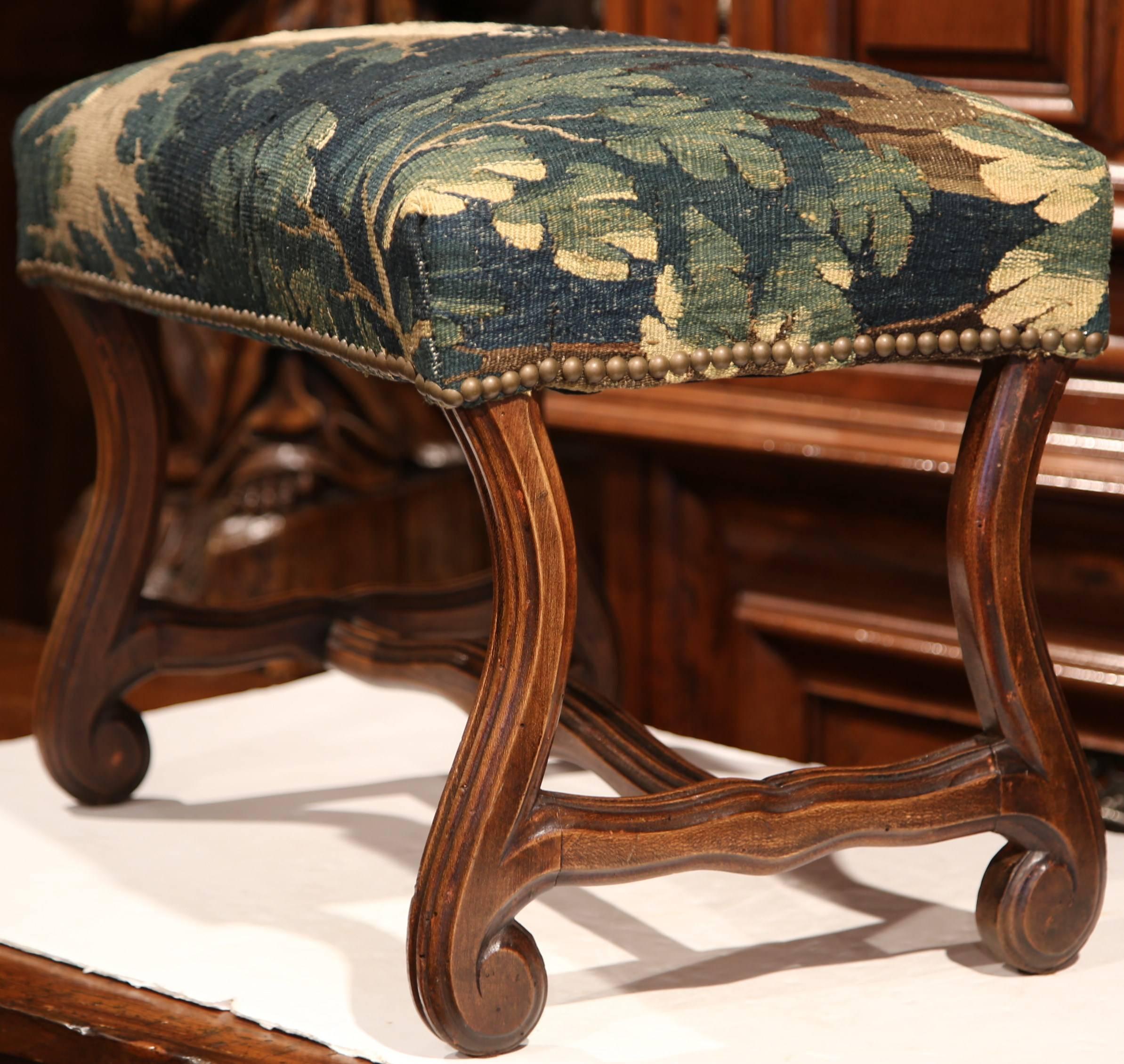 This simple, antique stool is an easy addition to a living room or study. The elegant fruitwood stool was crafted in France, circa 1880; it features a nicely carved base with rounded feet and has been upholstered with an old verdure Aubusson