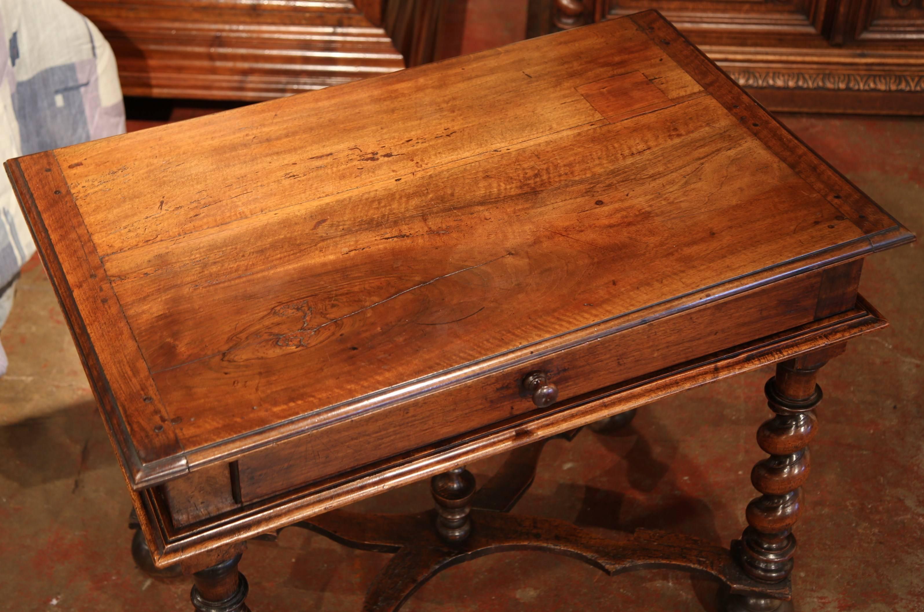 Incorporate extra, functional surface space into your living room with this elegant fruit wood end table. Crafted in the Perigord region of France circa 1790, this small desk features a single drawer across the front with a wooden knob. The writing