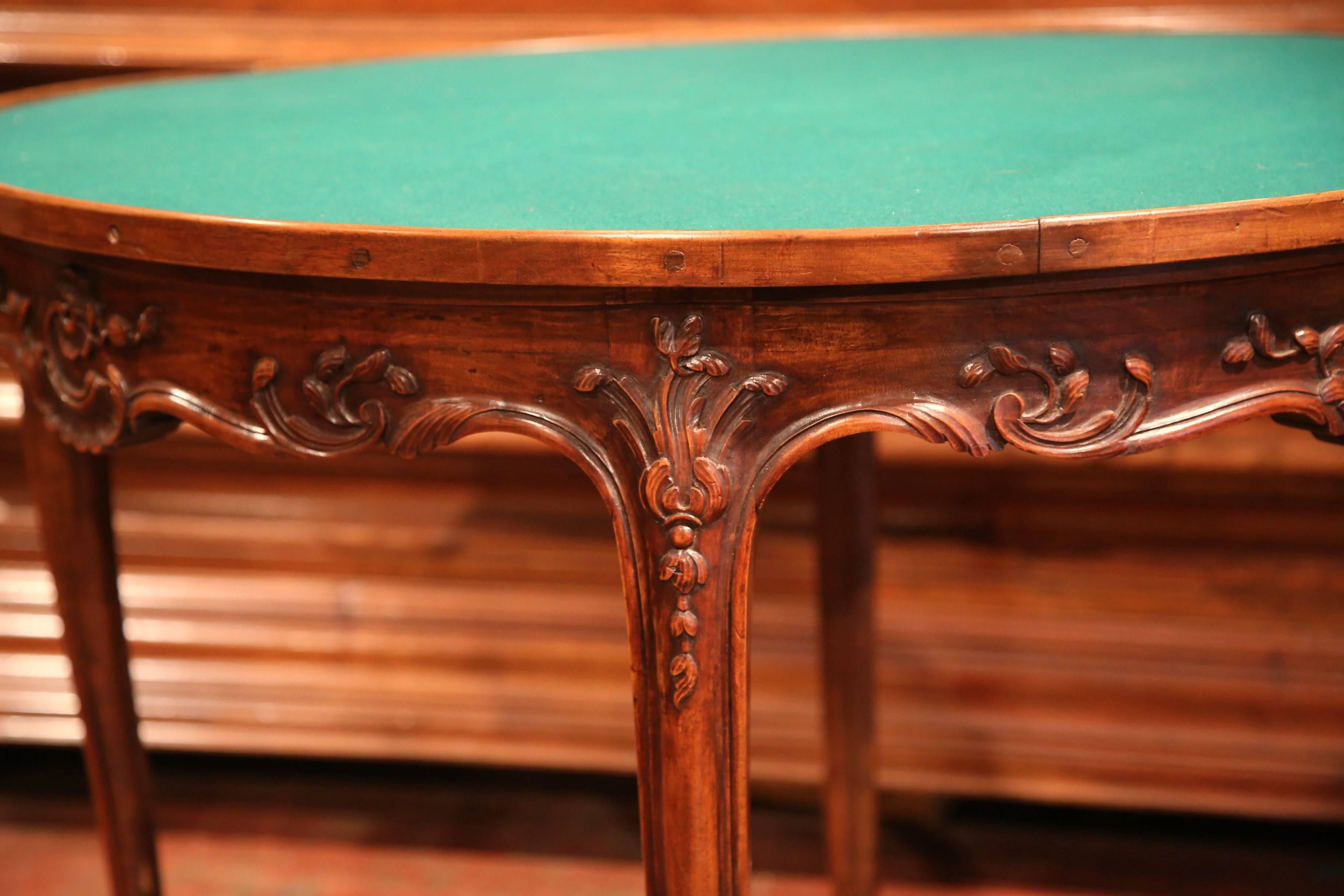 Originally used for card games, this round table is covered with a green felt top finished with a wooden edge all around. The elegant fruitwood game table from France, features four curved cabriole legs and a shaped apron with deep decorative