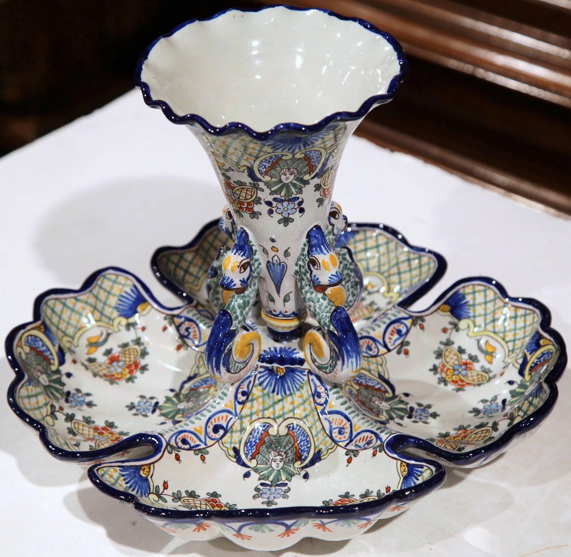 This elegant antique dish was sculpted in Nevers, Central France, circa 1910. The colorful piece has four separate contiguous compartments, embellished with a tall vase in the center. The piece is signed on the bottom 