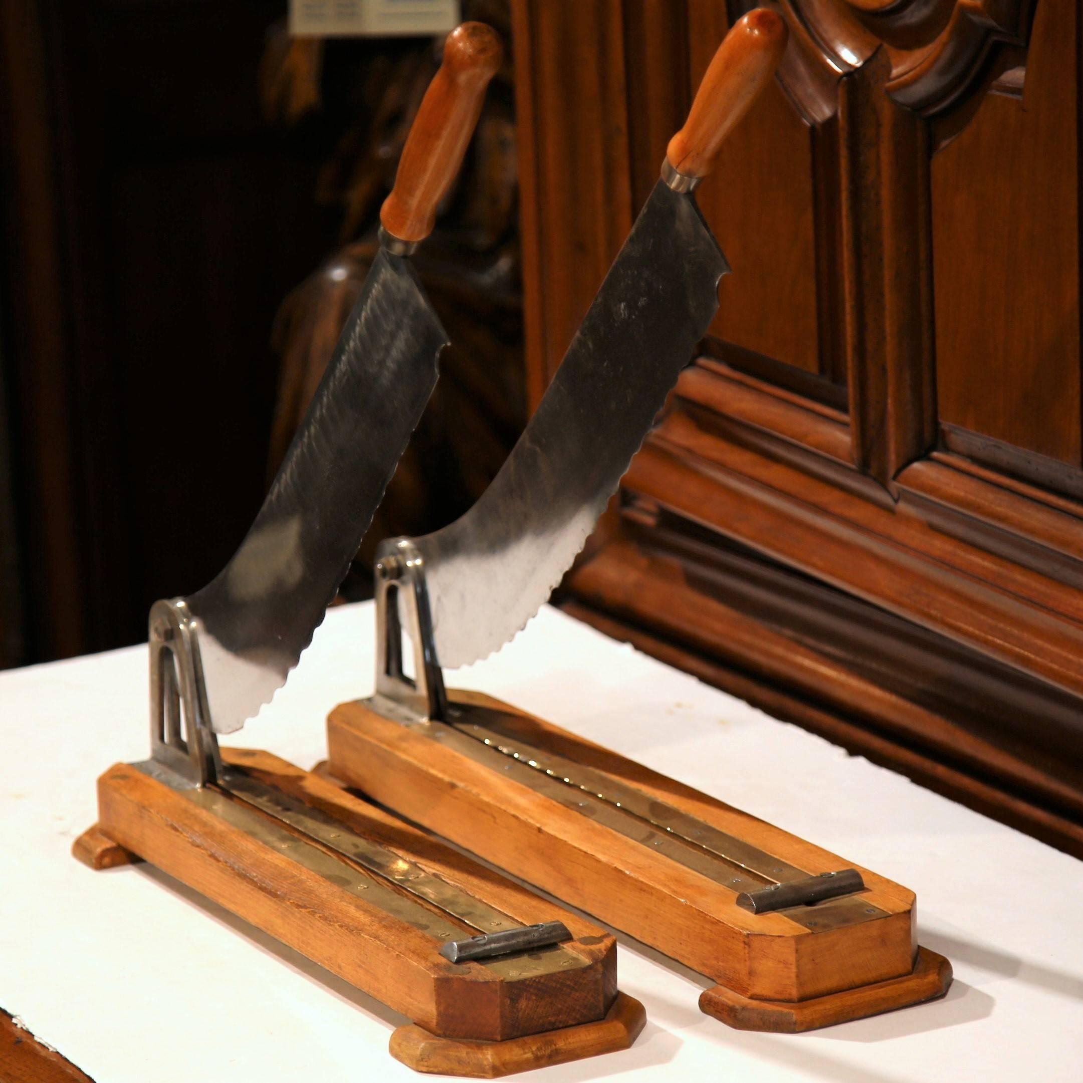 Add a little country French charm to your kitchen with this fine pair of working bread cutters with wood handles; crafted in Paris, France, circa 1880, the bread cutters are very simple and rustic and style, and have very sharp blades for easy use.