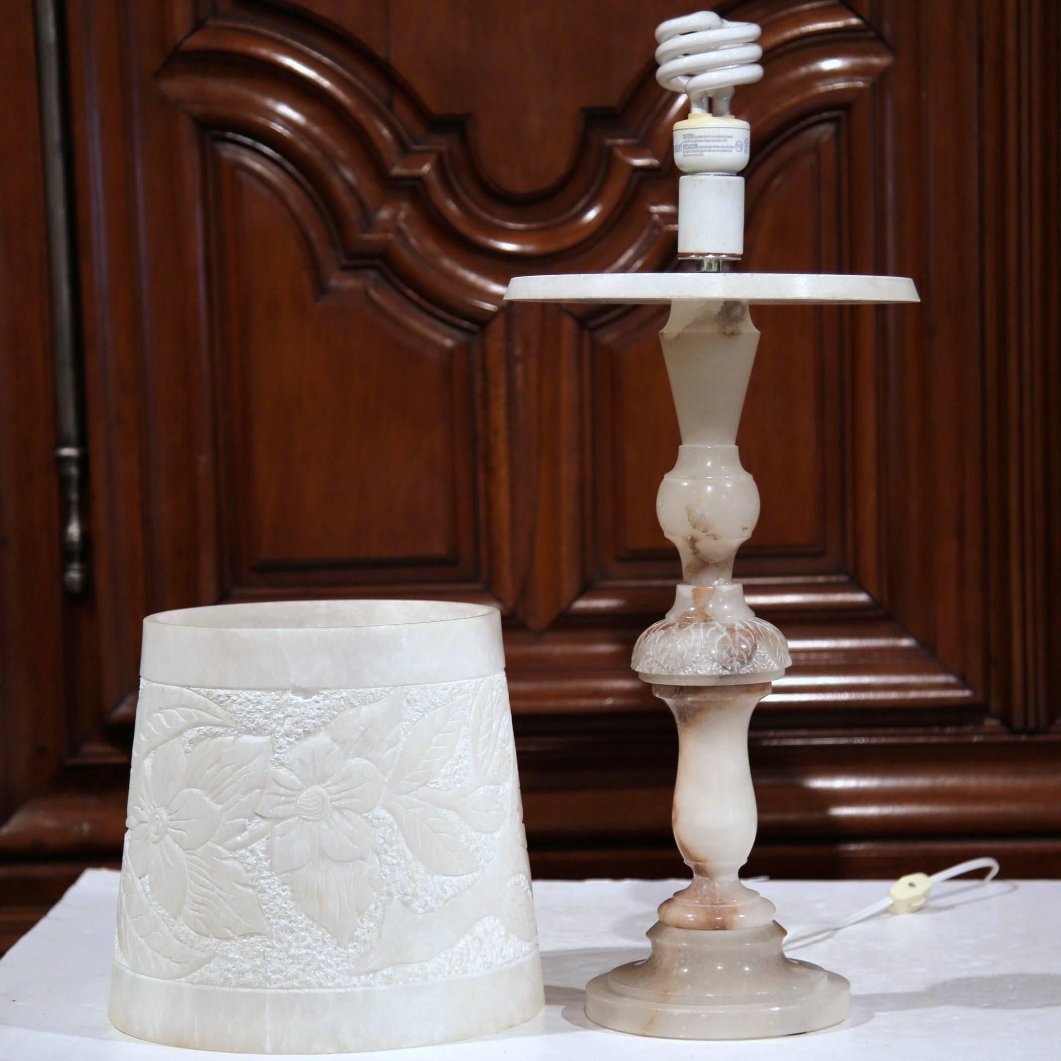 This unique, antique marble lamp has a perfectly contemporary look that would be beautiful in a number of homes. Crafted in France, circa 1900, the lamp has a carved white base with grey veins that's sculpted in an interesting way. The matching