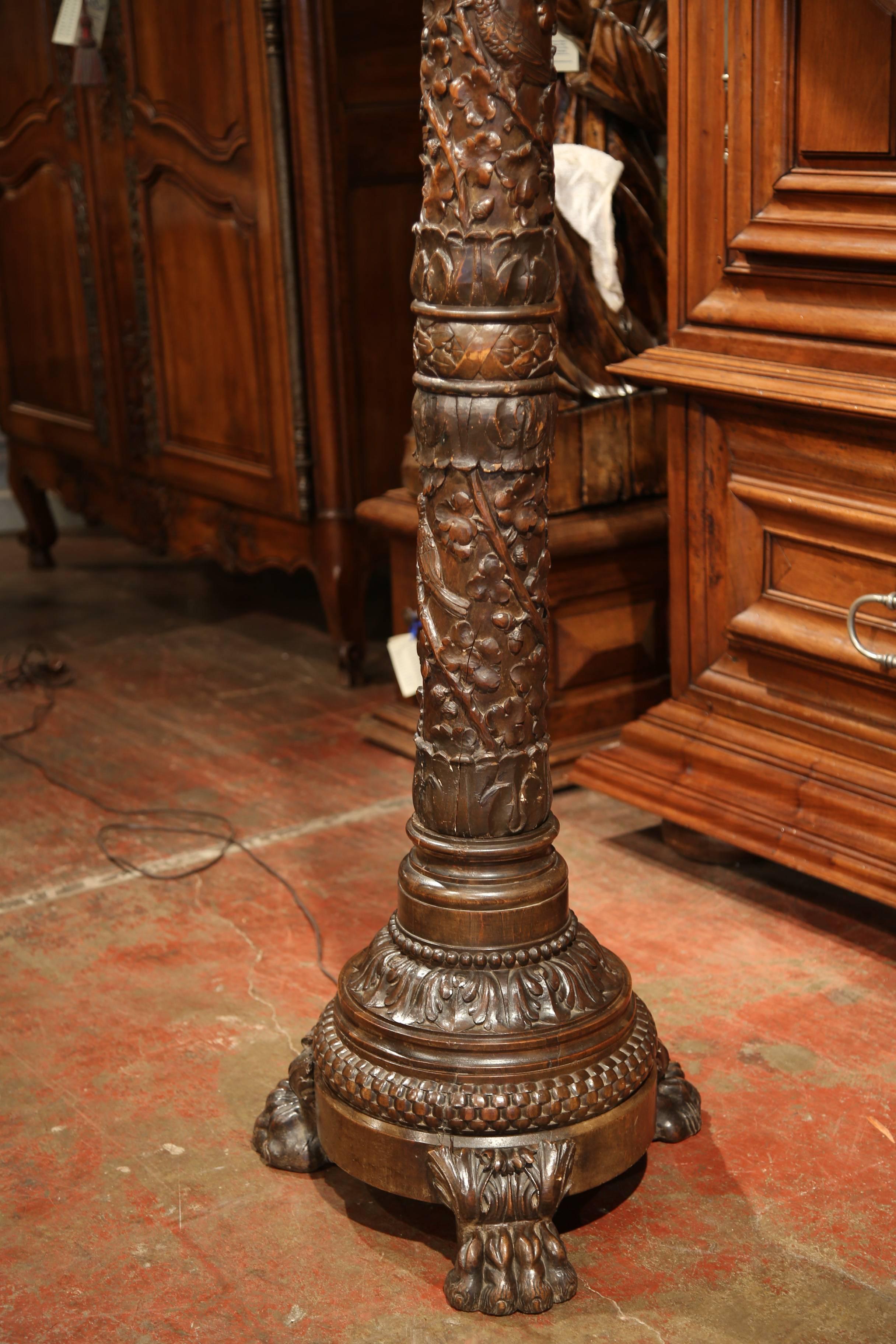 This beautifully carved oak lamp base was crafted in northern France, circa 1860. Sited on a base with three paw feet, the thick, round stem has intricate high relief carvings including birds, acorns, leaves and branches. The fixture has new wiring