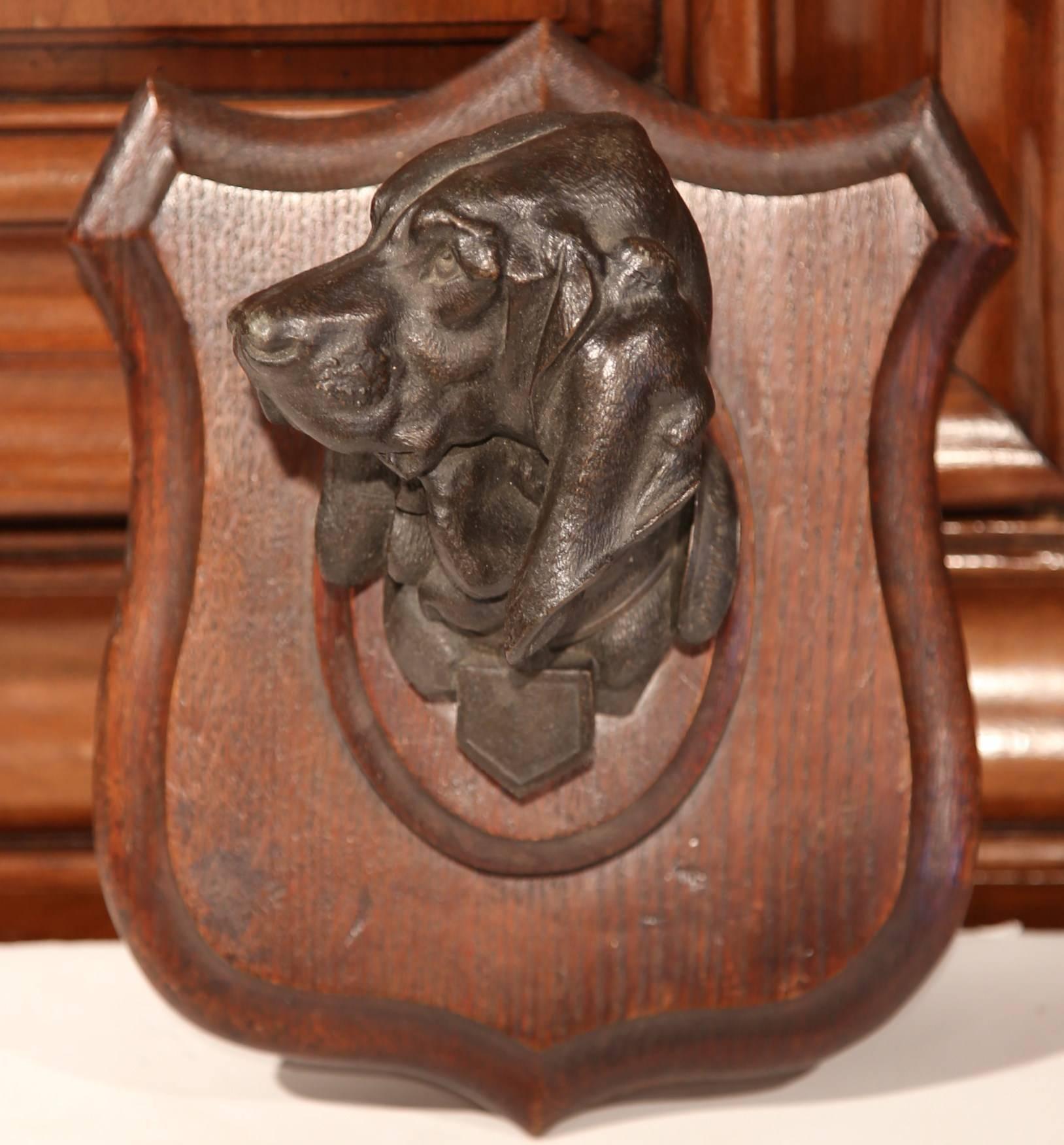 Bring the French countryside into your home with this beautiful hanging plaque. Crafted in France, circa 1890, this plaque features a high relief bronze hound dog sculpture. The dog is signed on the collar, Lecourtier. The piece would make an