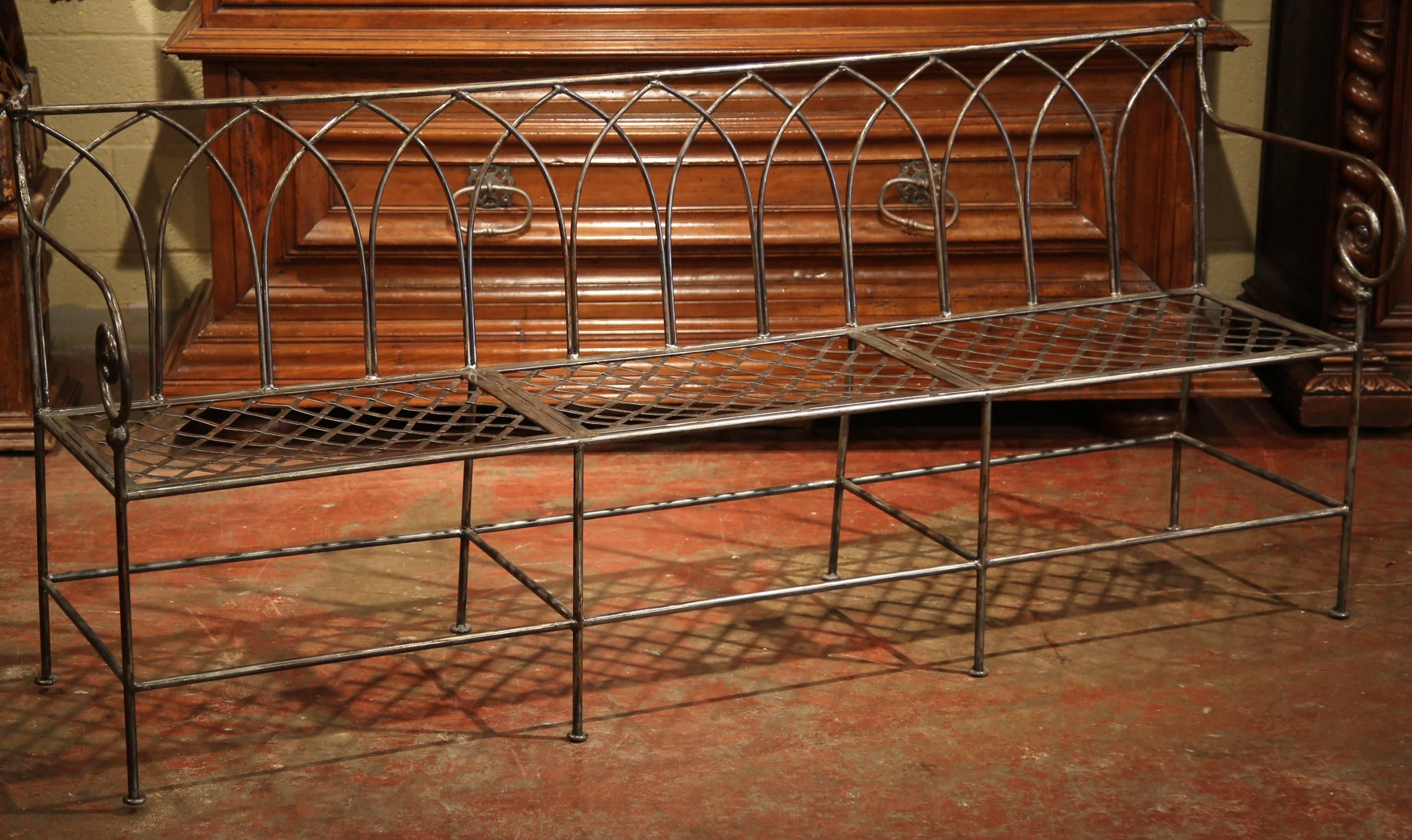 Add extra seating to a mudroom or covered outdoors space with this nicely forged iron bench from France. The simple bench stands on eight straight legs embellished with a rectangular bottom stretcher. The bench with curved arms, features a weave