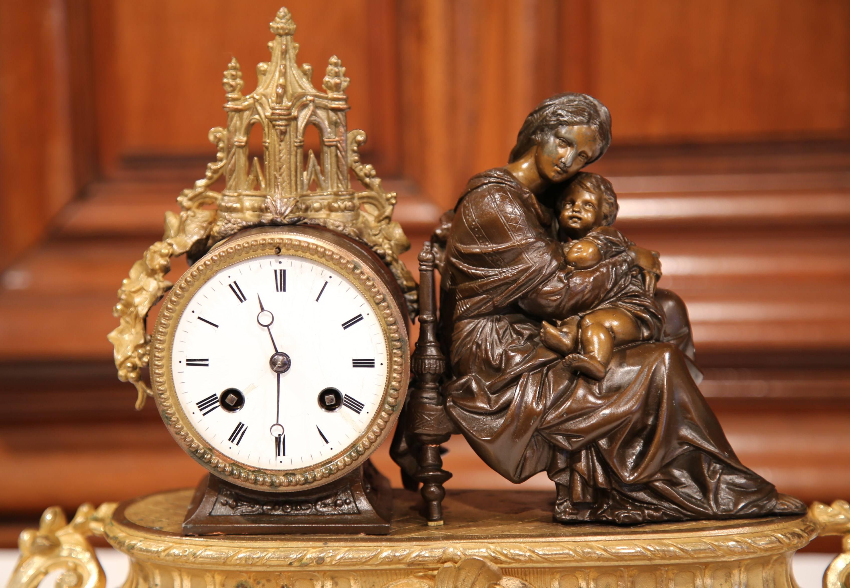 Embellish your desk or mantel with this exquisite antique desk clock from Paris, France, circa 1860. The timepiece features the Virgin Mary sitting on a chair holding baby Jesus. On the left side, there is a round, analogue clock in wonderful