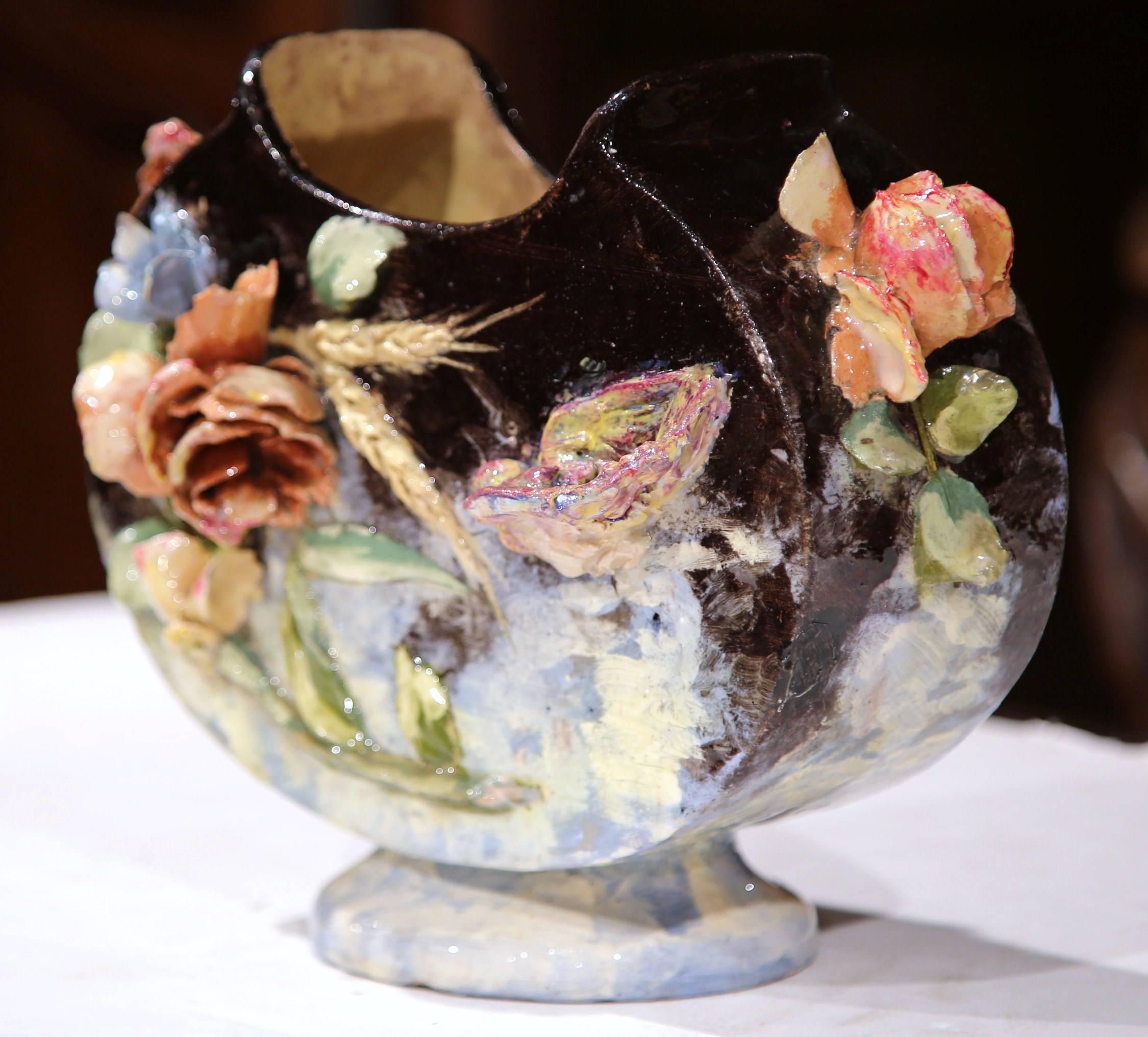 This colorful, antique Majolica vase was sculpted in Montigny sur Loing, France, circa 1860. Oval in shape, this jardinière features natural motifs in high relief including flowers, leaves, wheat and a bird. Use the planter in a living room or