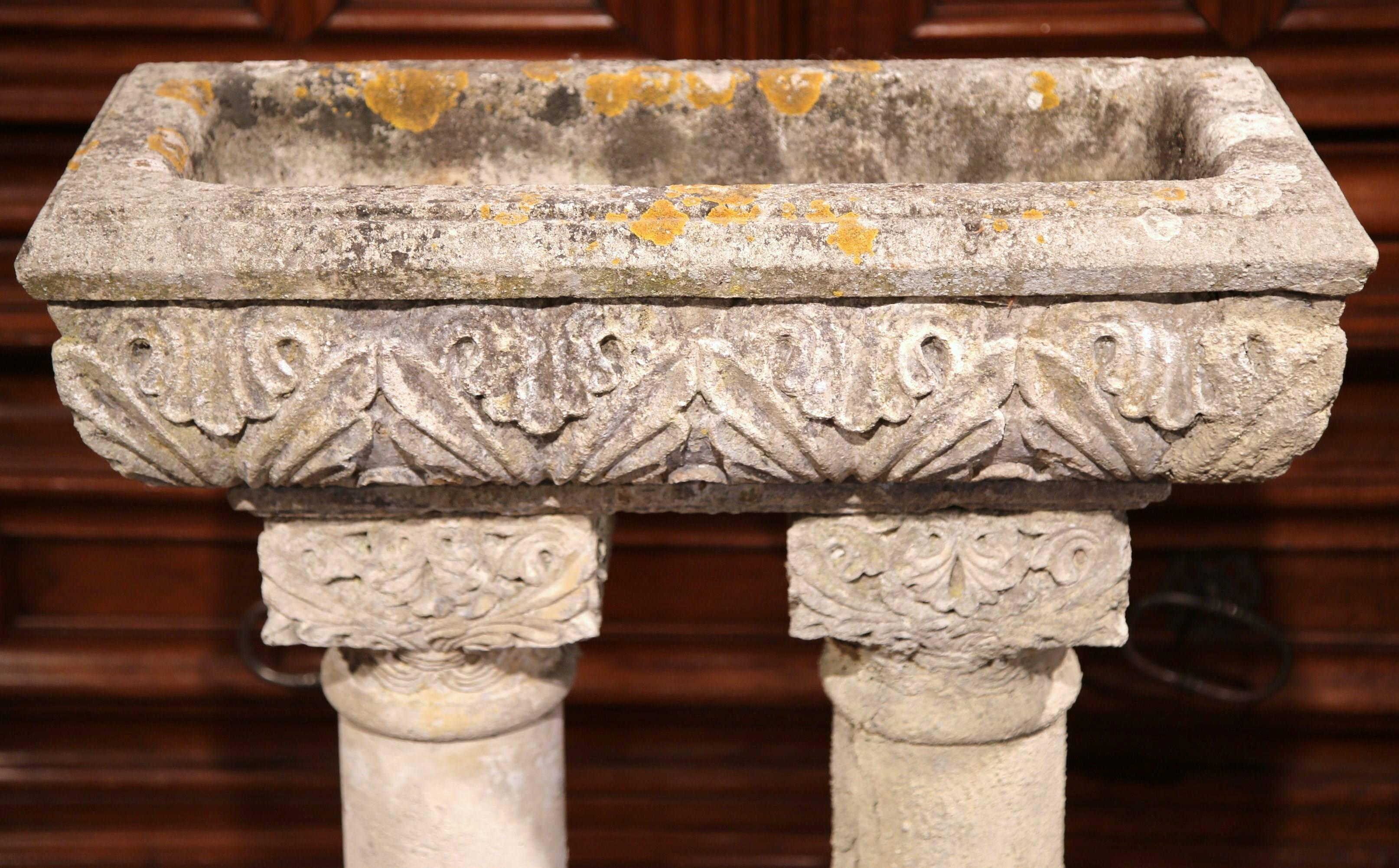 This impressive, antique cast stone planter was carved on the Normand coast of France, circa 1850. Made in two sections, this garden jardiniere features two circular columns on stepped rectangular base with a rectangular flower holder sitting on top