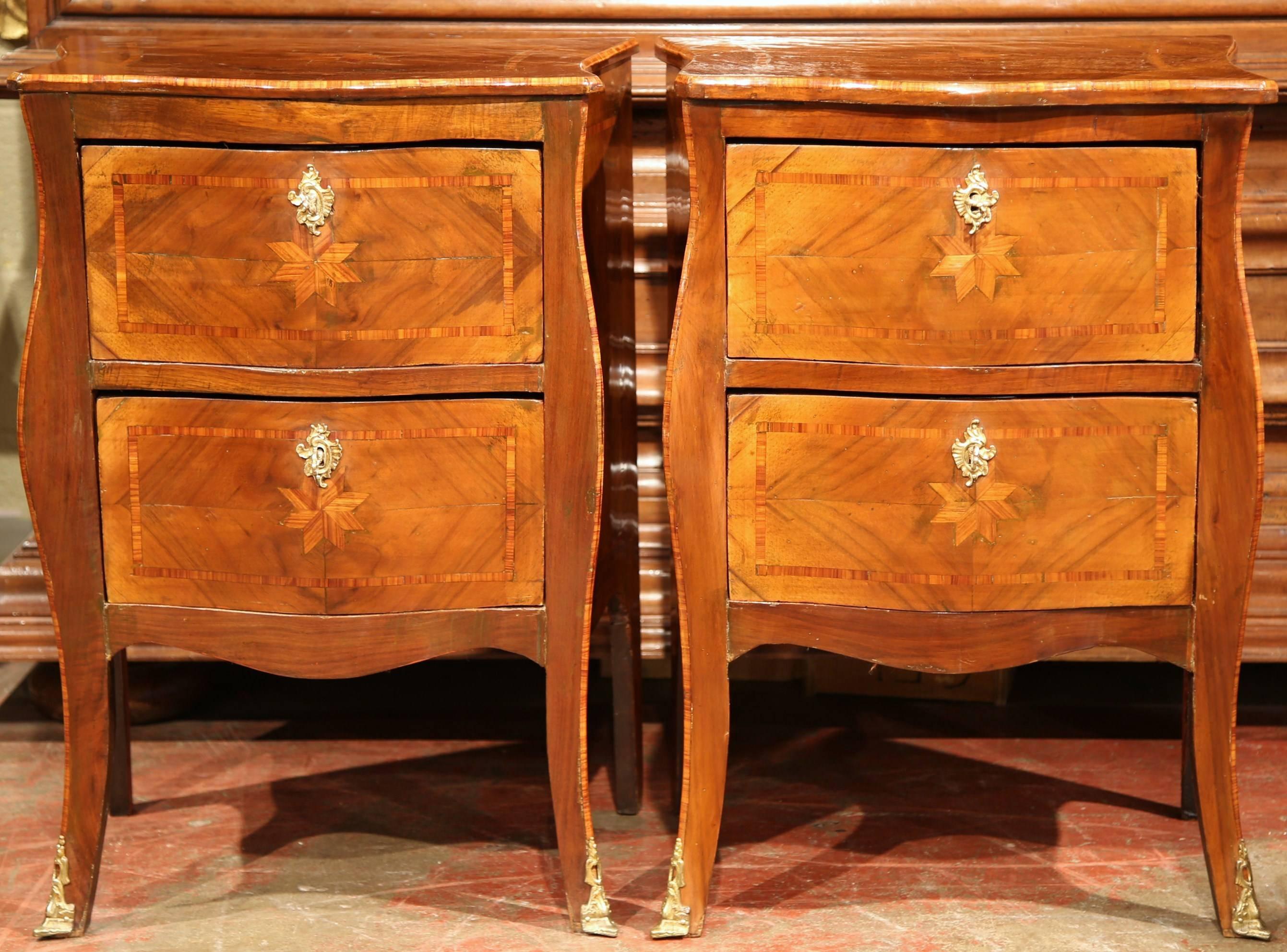 Complete your bedroom with this elegant pair of antique fruitwood bombe commodes. Crafted in Paris, France, circa 1860, each chest features beautiful marquetry work on all sides with a large star in the centre of each panel. The cabinets have two