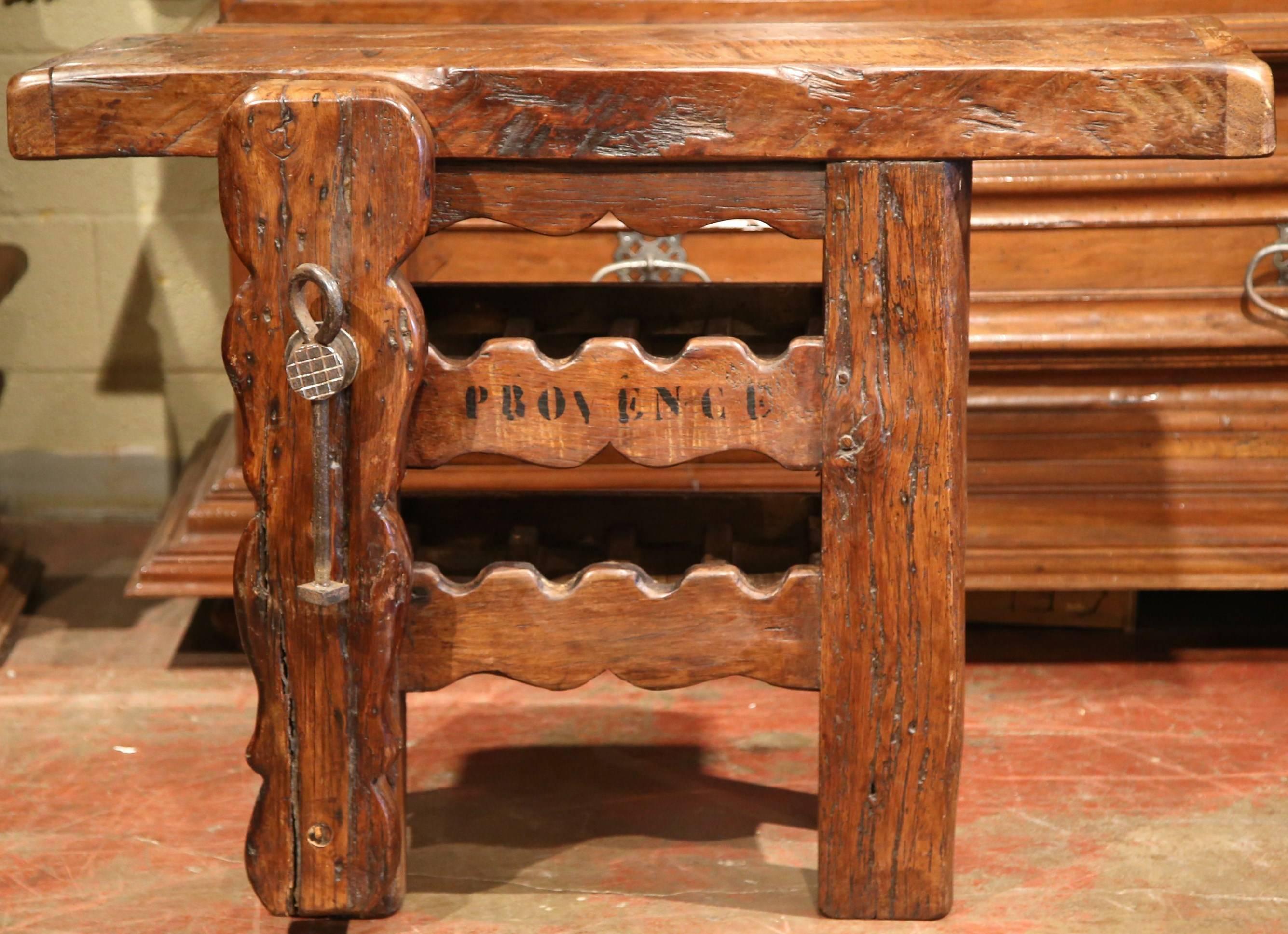 This antique table was crafted in the Poitou region of France, circa 1880. The country piece has a very thick top and features two rows underneath for the storage of wine bottles. The table also has 