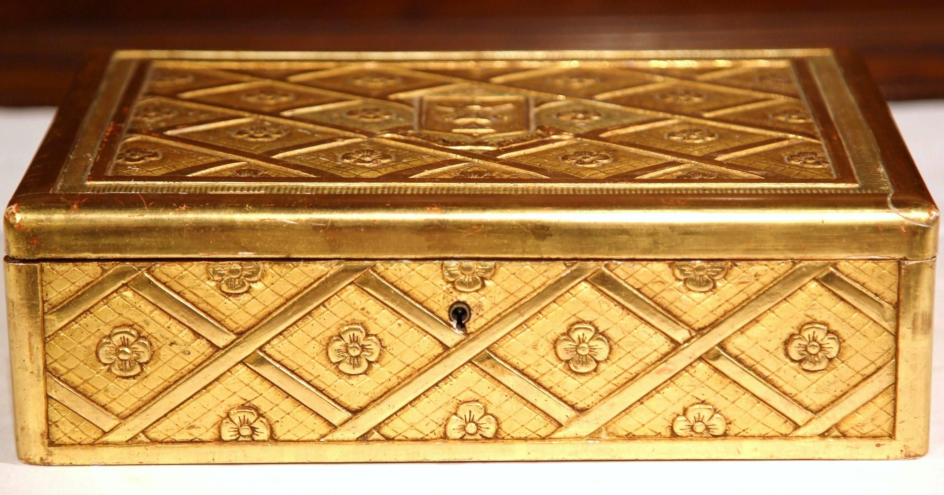This beautiful, carved, antique box was created in Paris, France, circa 1880. The piece has a diamond, lattice shape carving treatment throughout, and front has a crest with the following motto underneath: "tout est change" (everything has