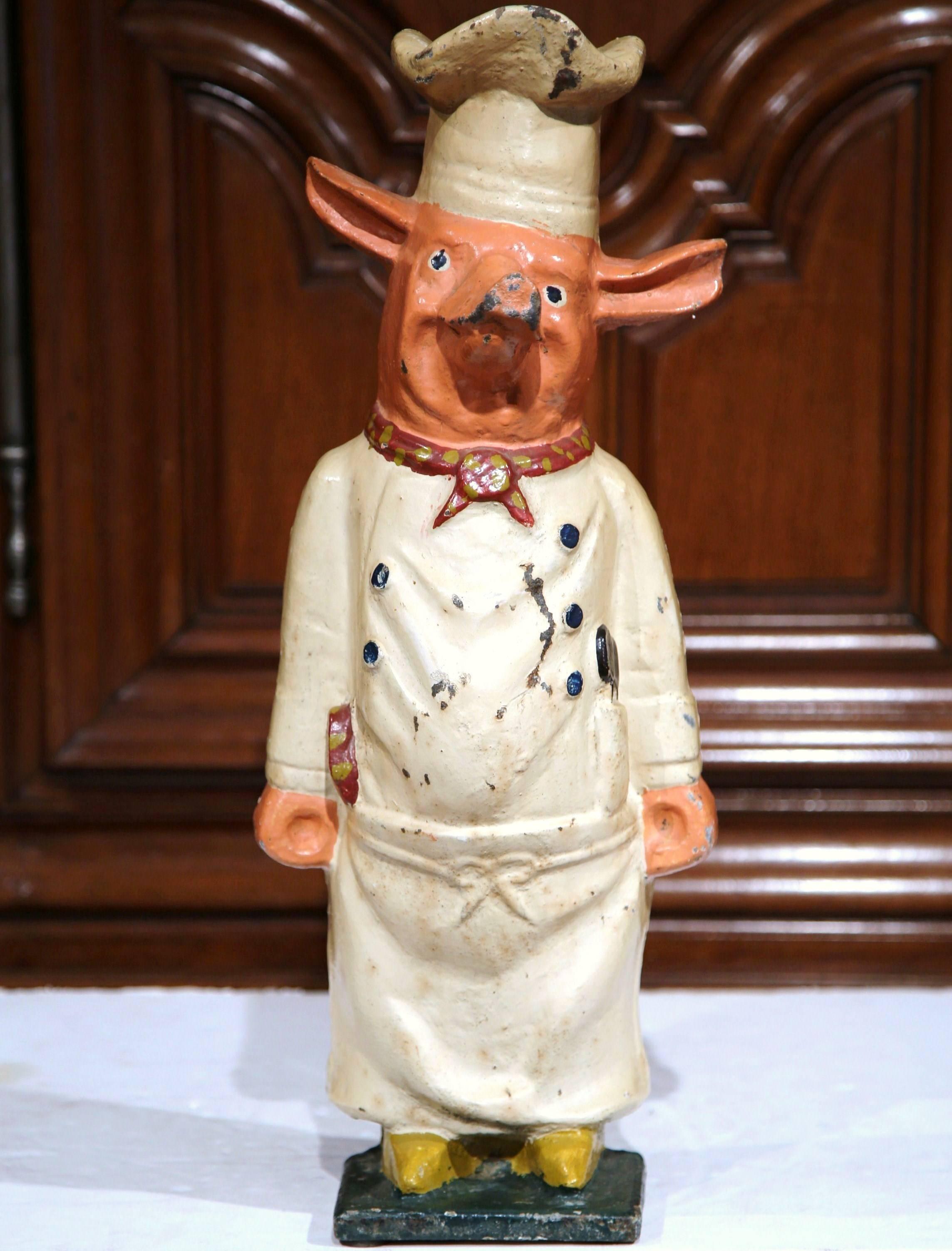 Add character to your kitchen with this playful cast iron pig statue from France, circa 1900. This hand-painted standing sculpture was found in a Paris restaurant and depicts a pig wearing a Classic chef's uniform. The piece is in excellent