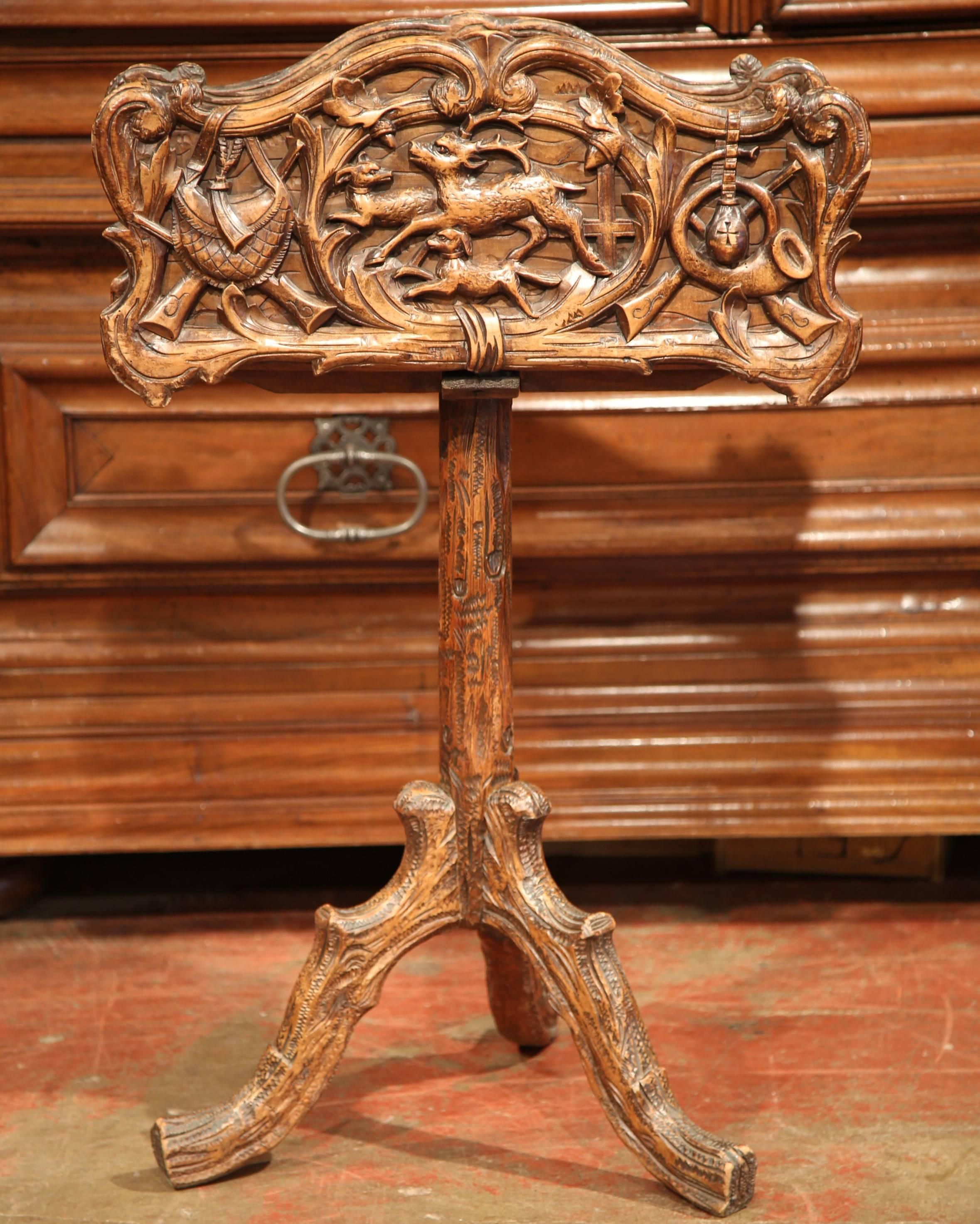 This beautiful, walnut Black Forest jardiniere was carved in France, circa 1880. The elevated planter features a hunting scene, a running deer with two dogs in the centre medallion, flanked by hunting attributes on both sides: a pair of guns with a