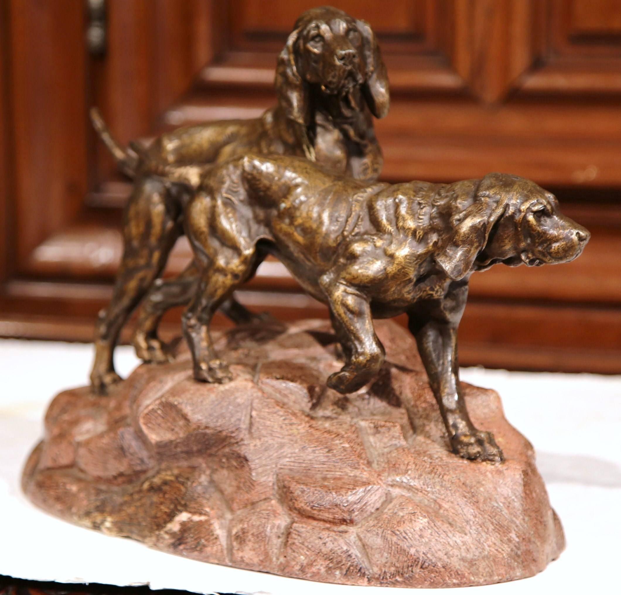 Decorate a shelf, table or desk in a study with this beautifully executed dog composition. Crafted in France, circa 1880, the sculpture features two patinated hunting dogs on of a textured terracotta mount. The active canines are tied up together as