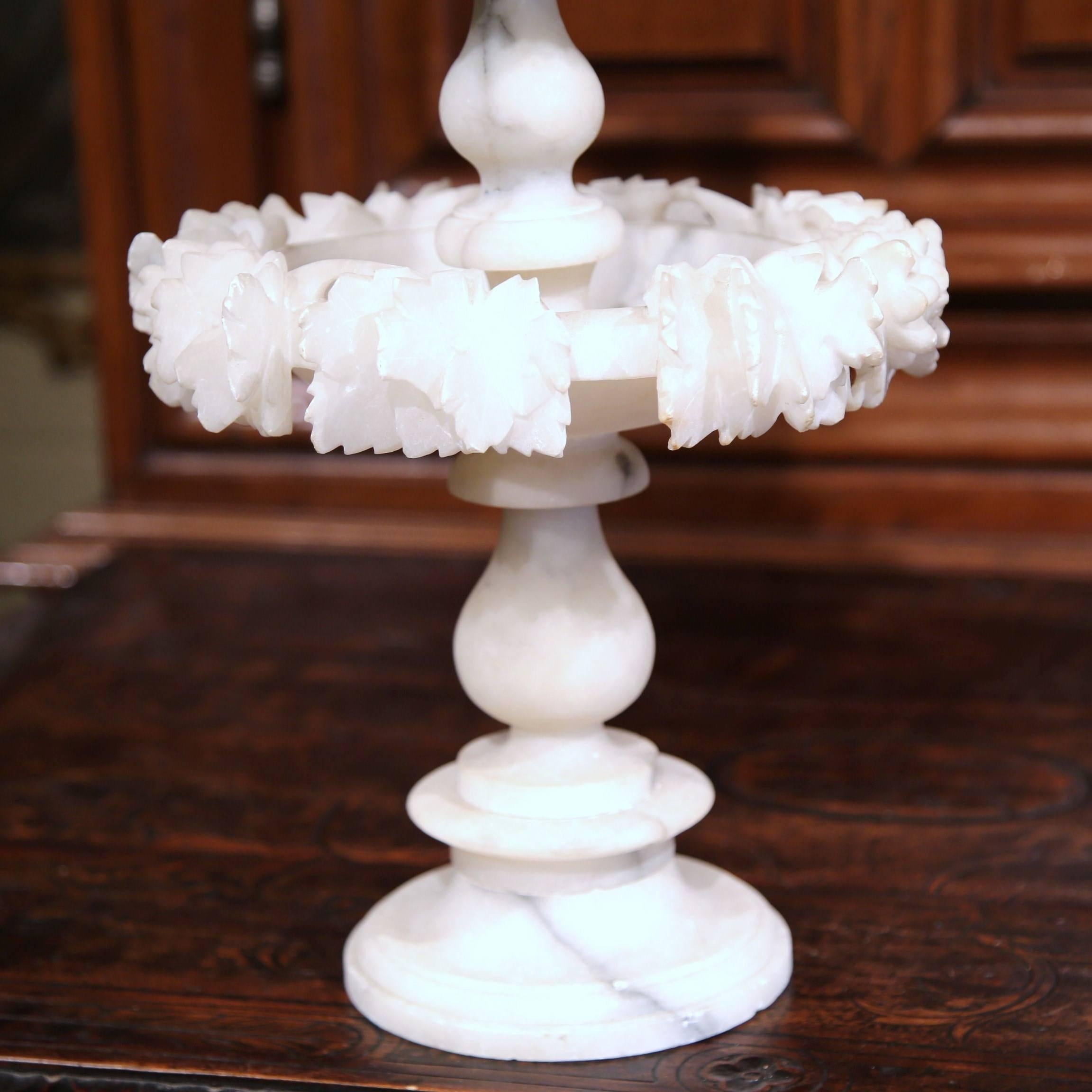 This elegant antique carved white alabaster centerpiece was sculpted in France, circa 1880. The display piece features three, embellished tiers and is crowned with a carved, decorative pediment. The shining decorative vase is in excellent condition