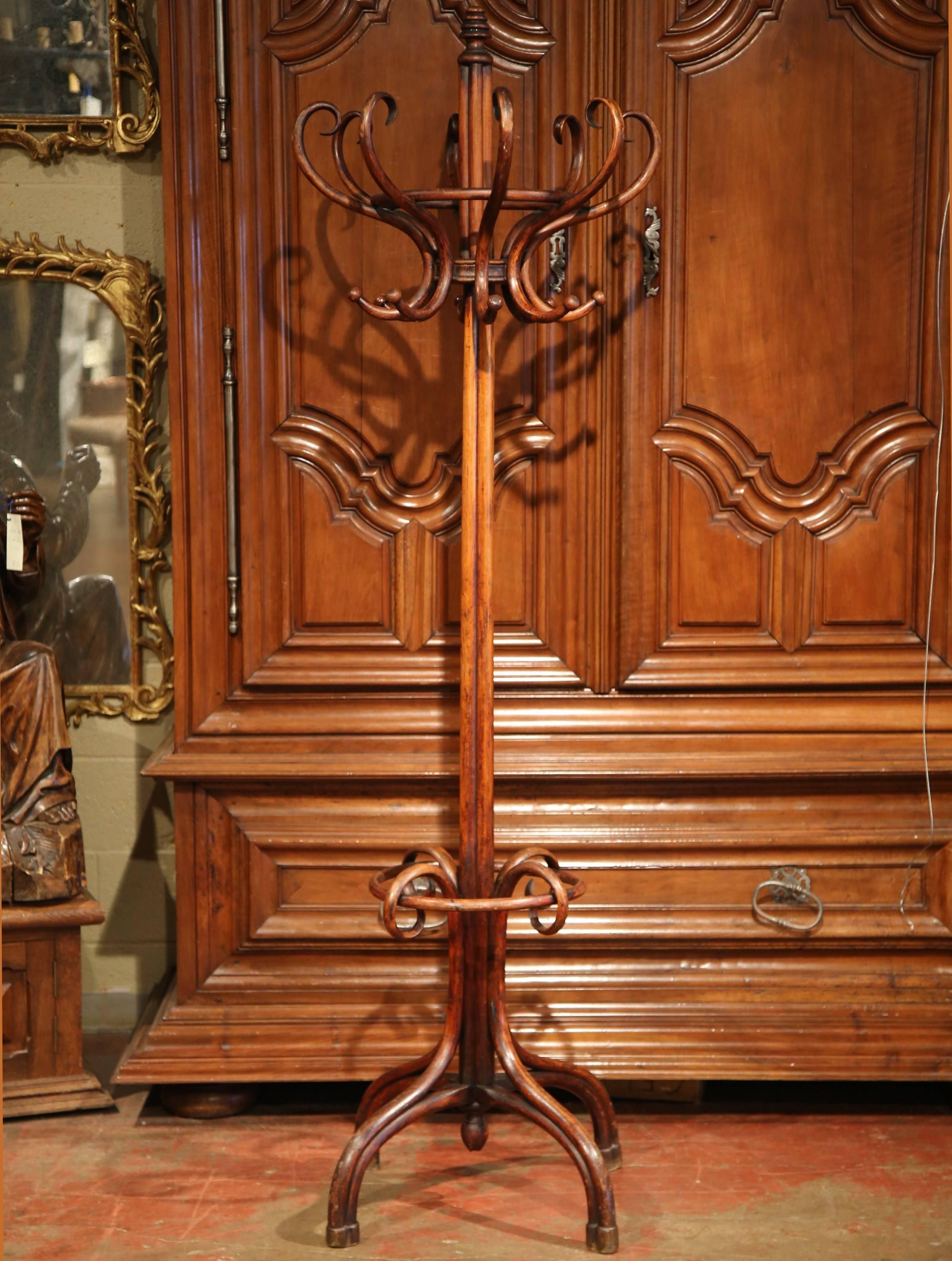Bring a retro, yet practical touch to any entry or dressing area with this elegant, carved coat Stand. The wooden coat Stand was crafted in Paris, France circa 1920, after the German-Austrian cabinet maker, Michael Thonet (1796-1871). The hall tree