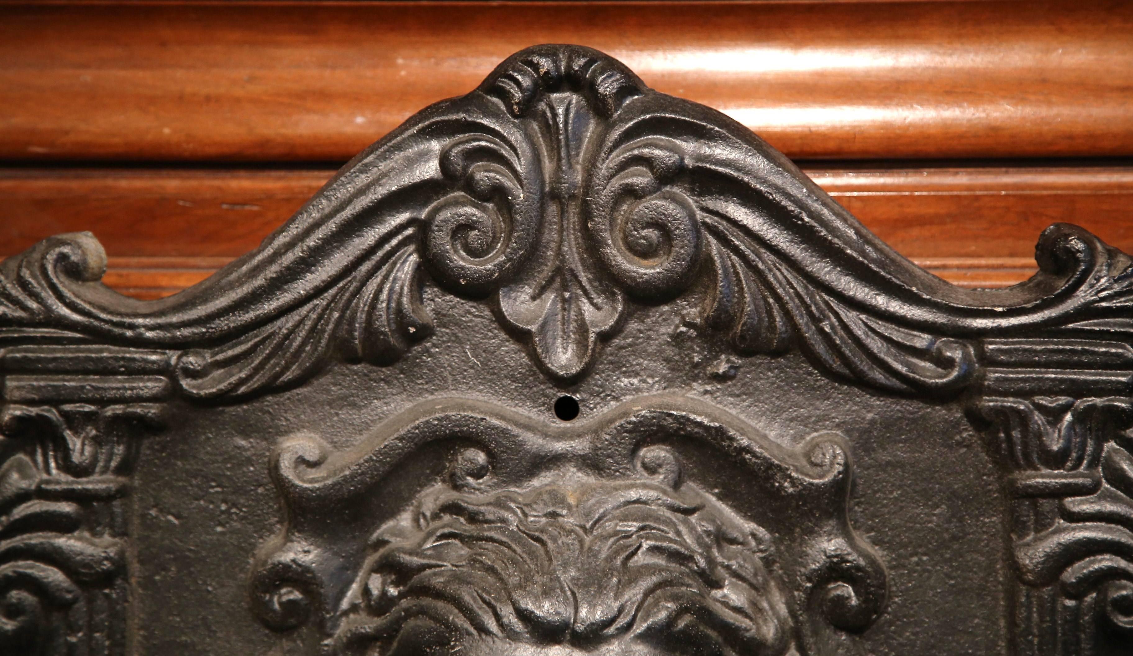 This fine antique wall fountain was crafted from cast iron in France, circa 1870. The exterior garden element features an expressive lion head surrounded by floral and decorative motifs. The spout is located directly under the lion, and below is a