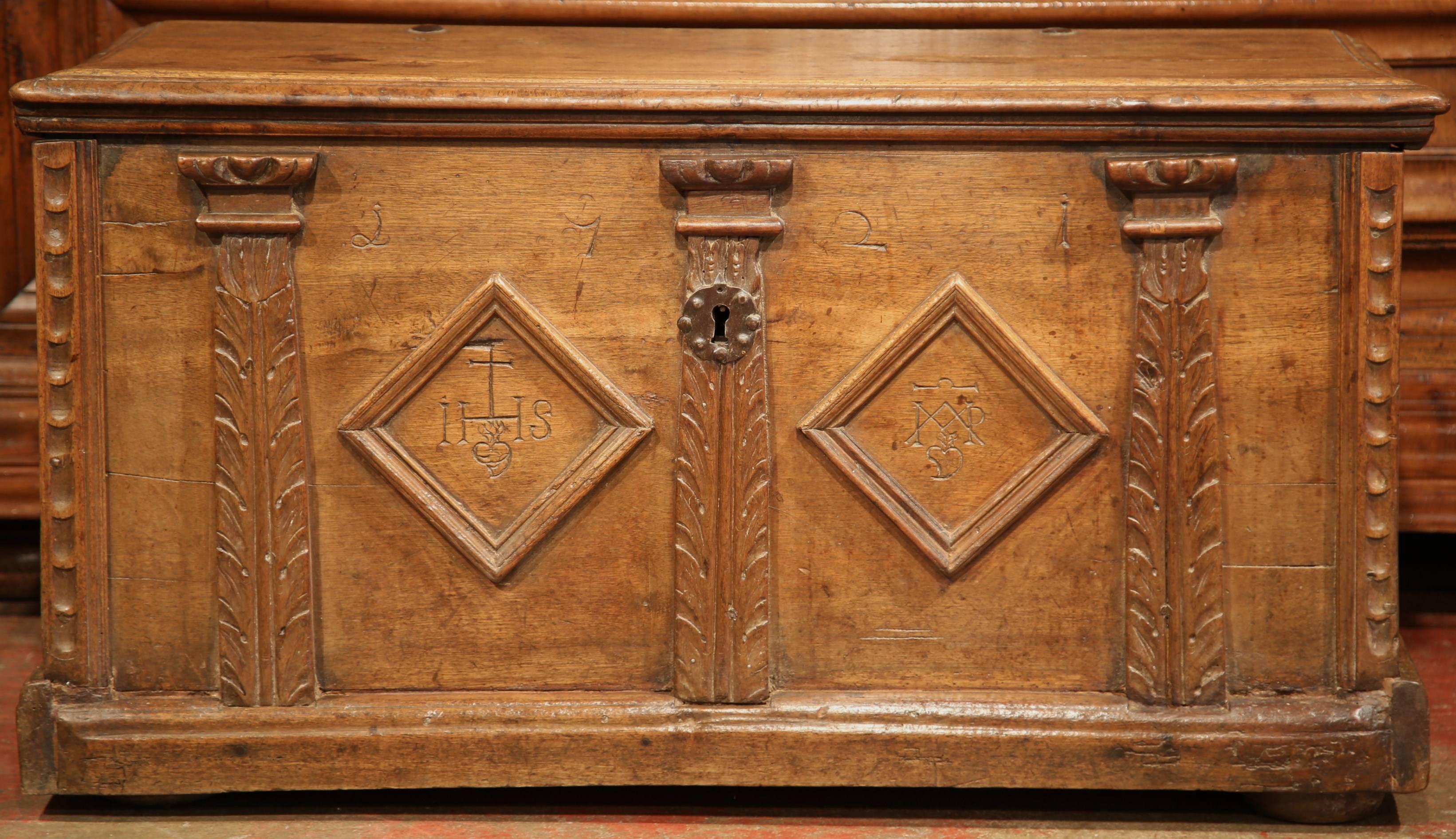 Store your winter blankets in this antique fruitwood trunk from the Perigord region of France. Crafted in the 17th century, circa 1660, this cabinet features two diamond shapes design across the front along with some initials, numbers and other
