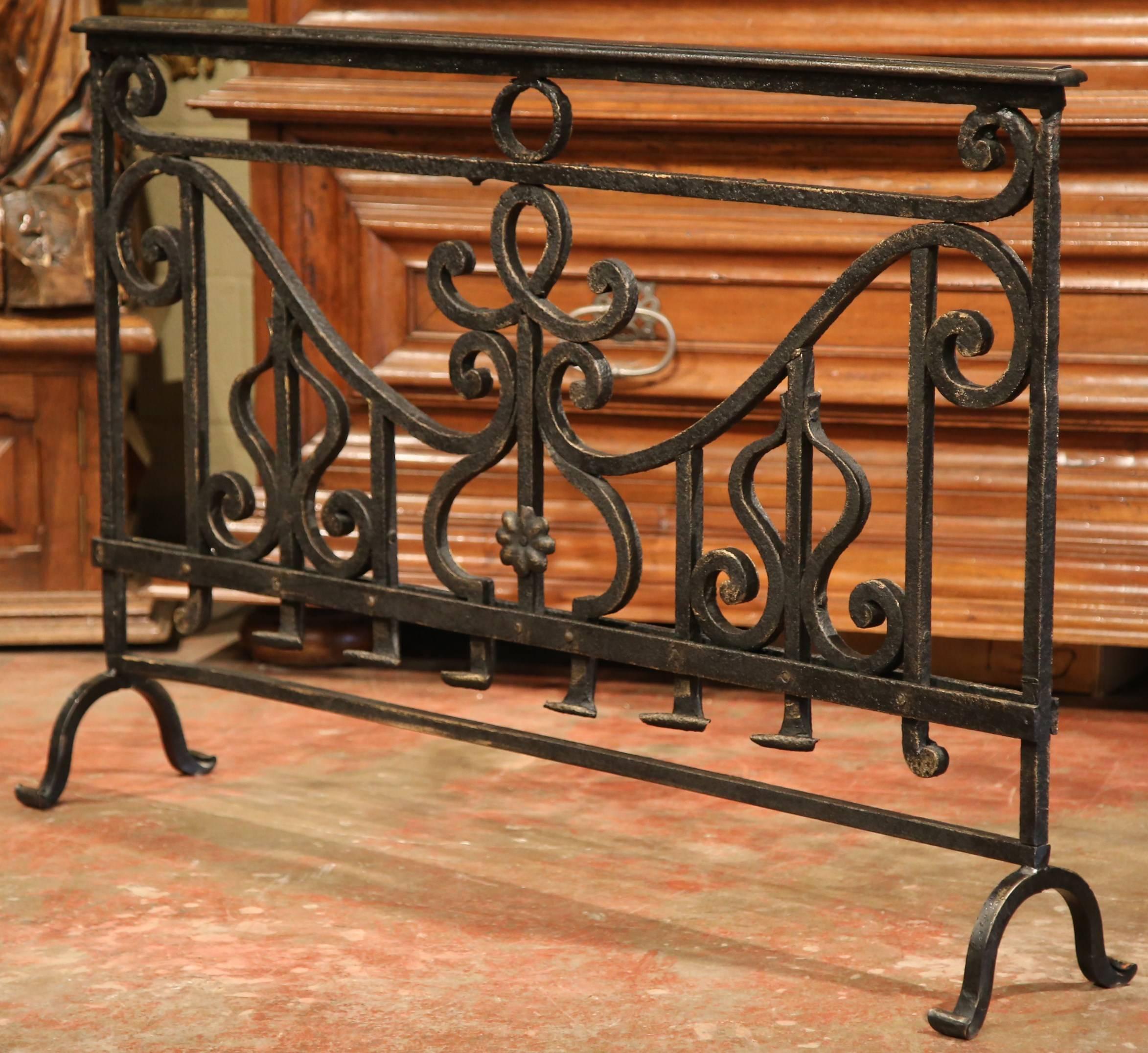 Embellish your fireplace in the living room, dining room or bedroom with this heavy, antique fireplace screen. Forged in France, circa 1780, the Classic wrought iron screen stands on curved feet at each end and has its original painted patina. The